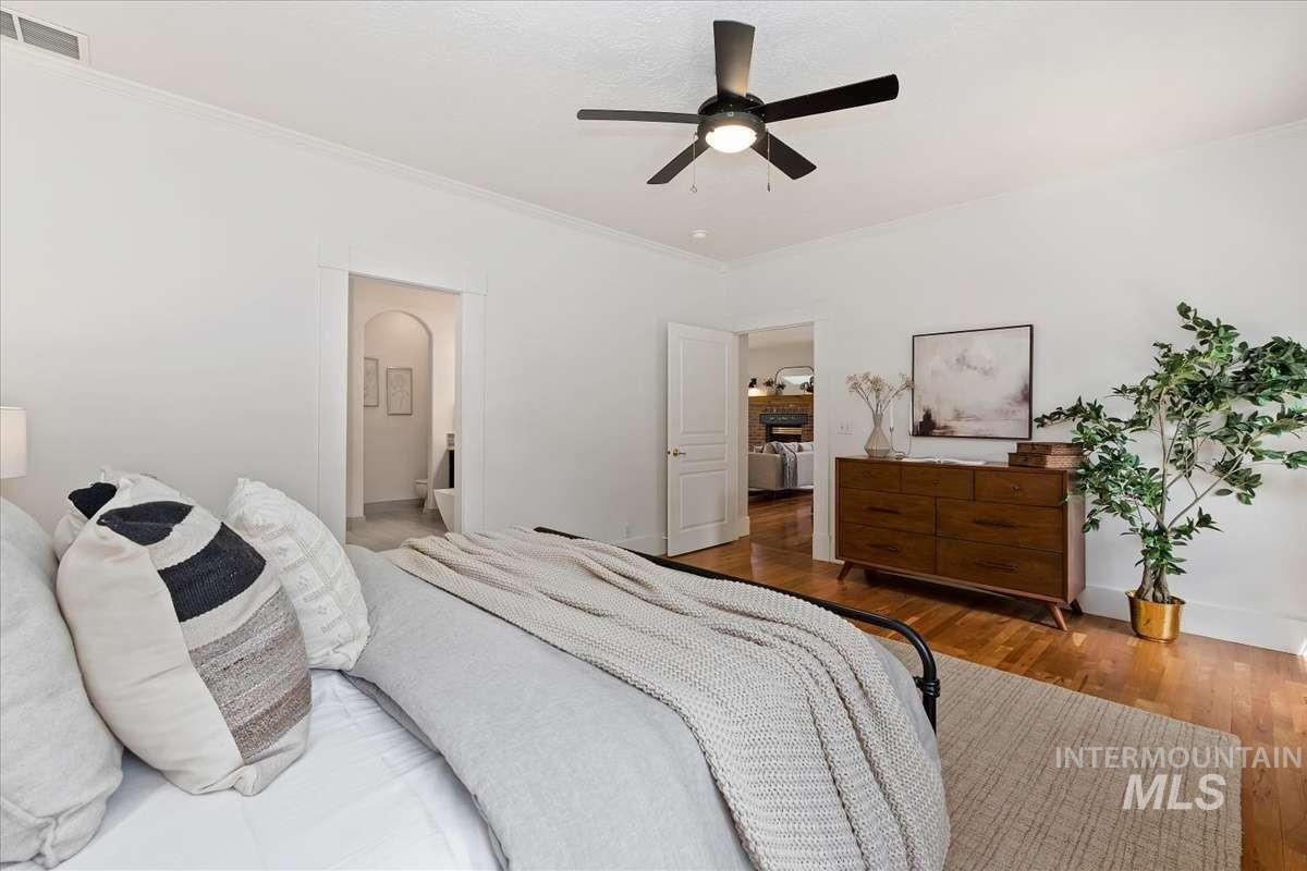Hardwood flooring complements crisp white walls and crown molding