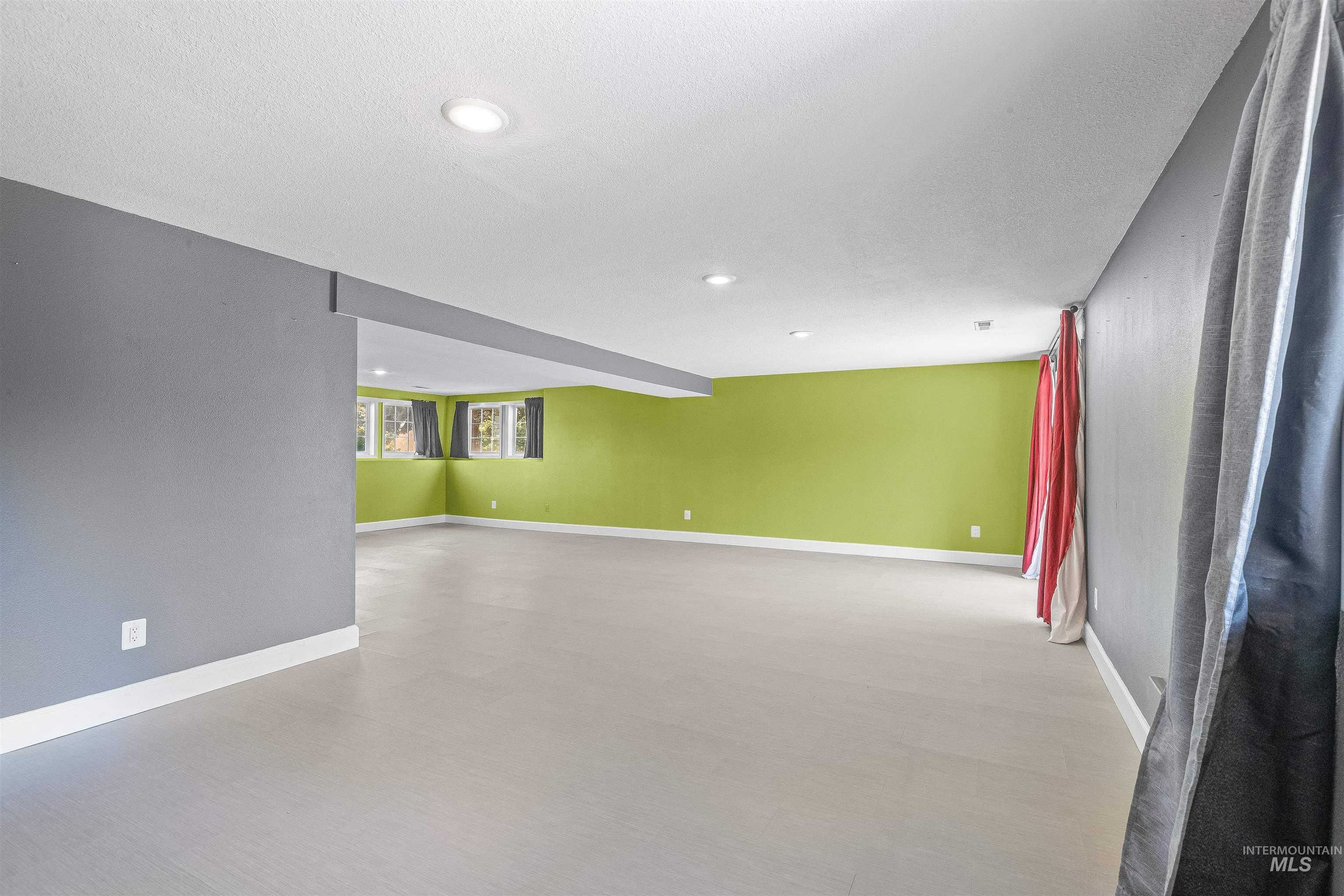 Spare room with recessed lighting and baseboards