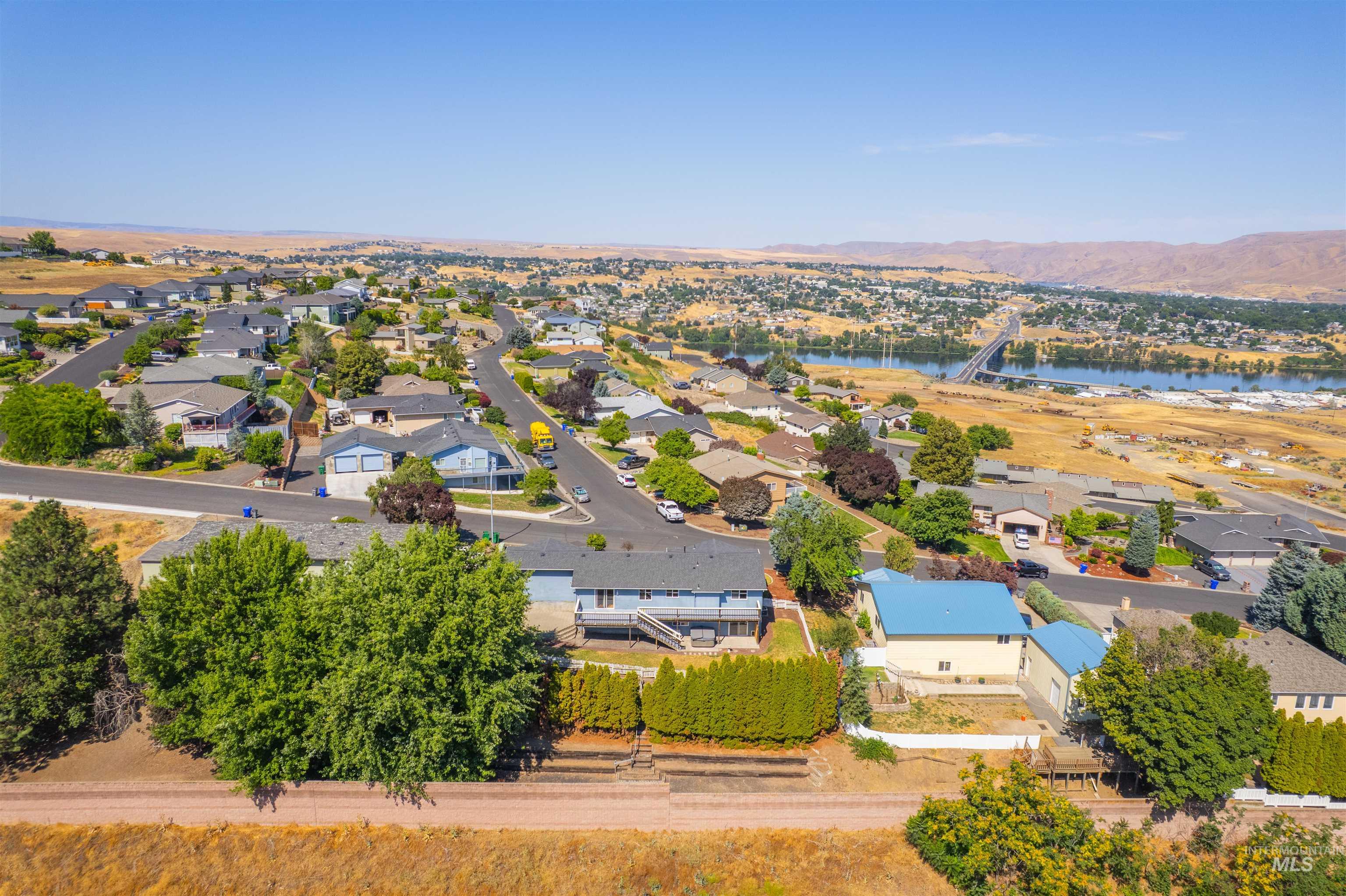 Aerial view of residential area featuring a nearby body of water