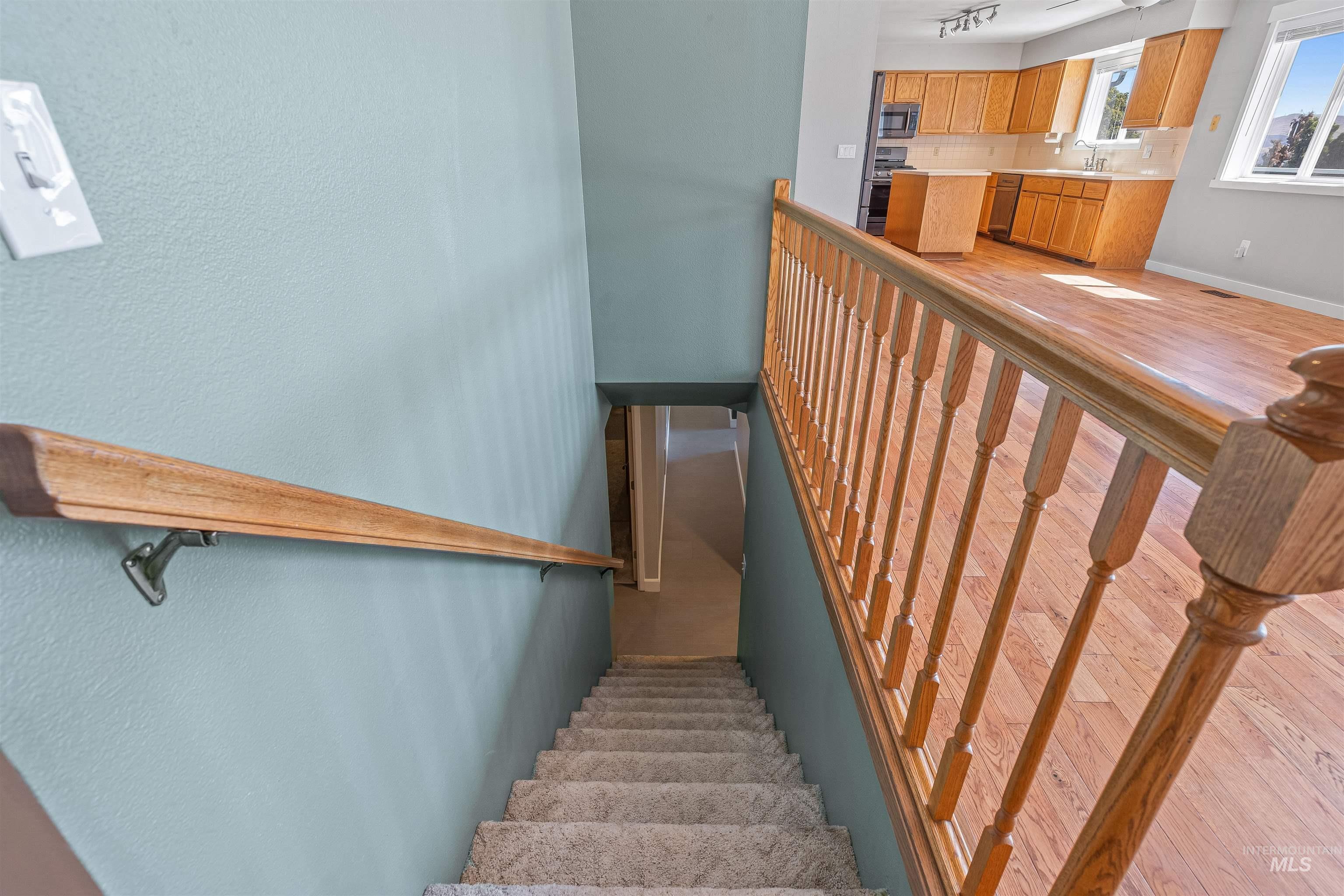 Stairway with baseboards and wood finished floors
