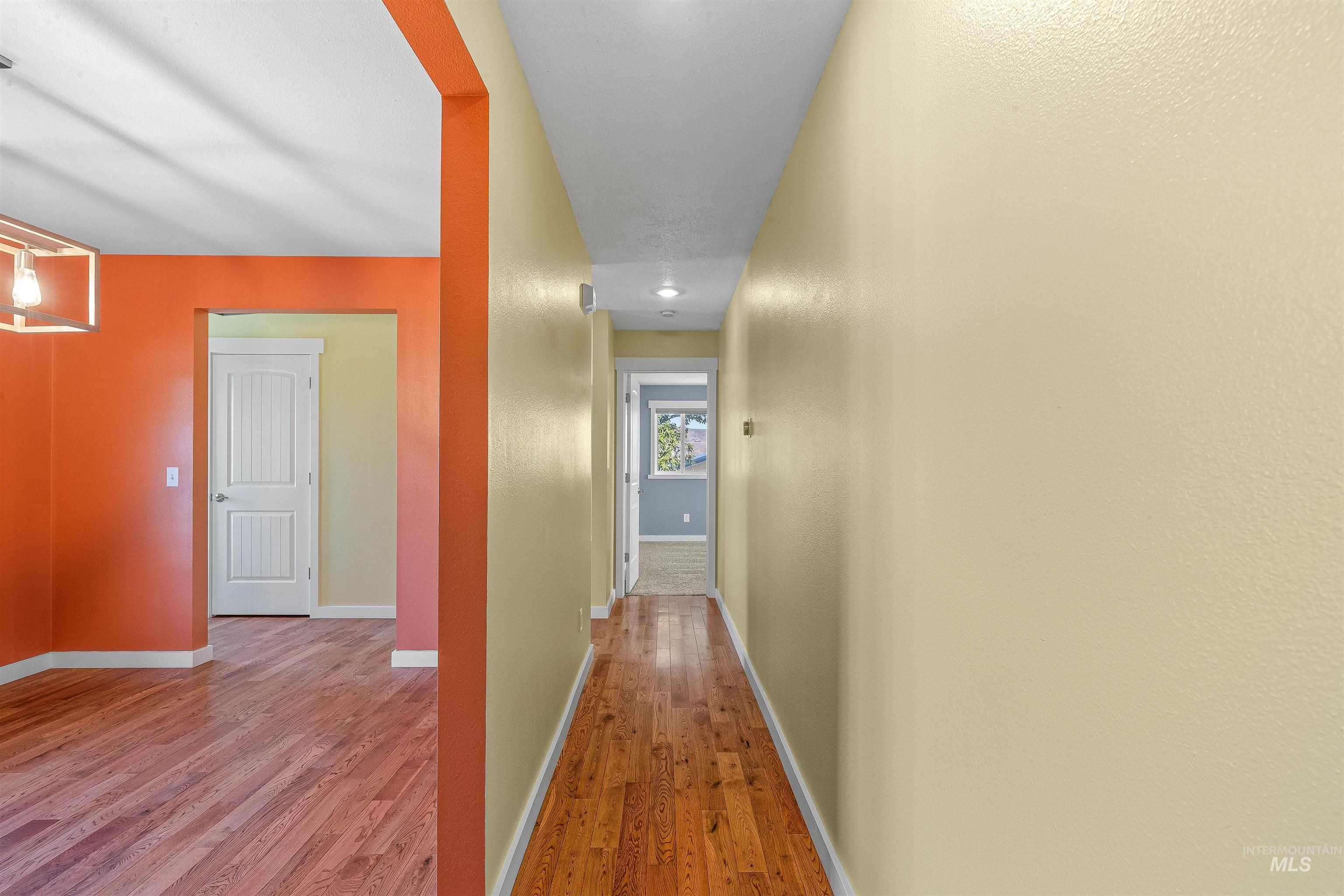 Hall with wood finished floors and baseboards