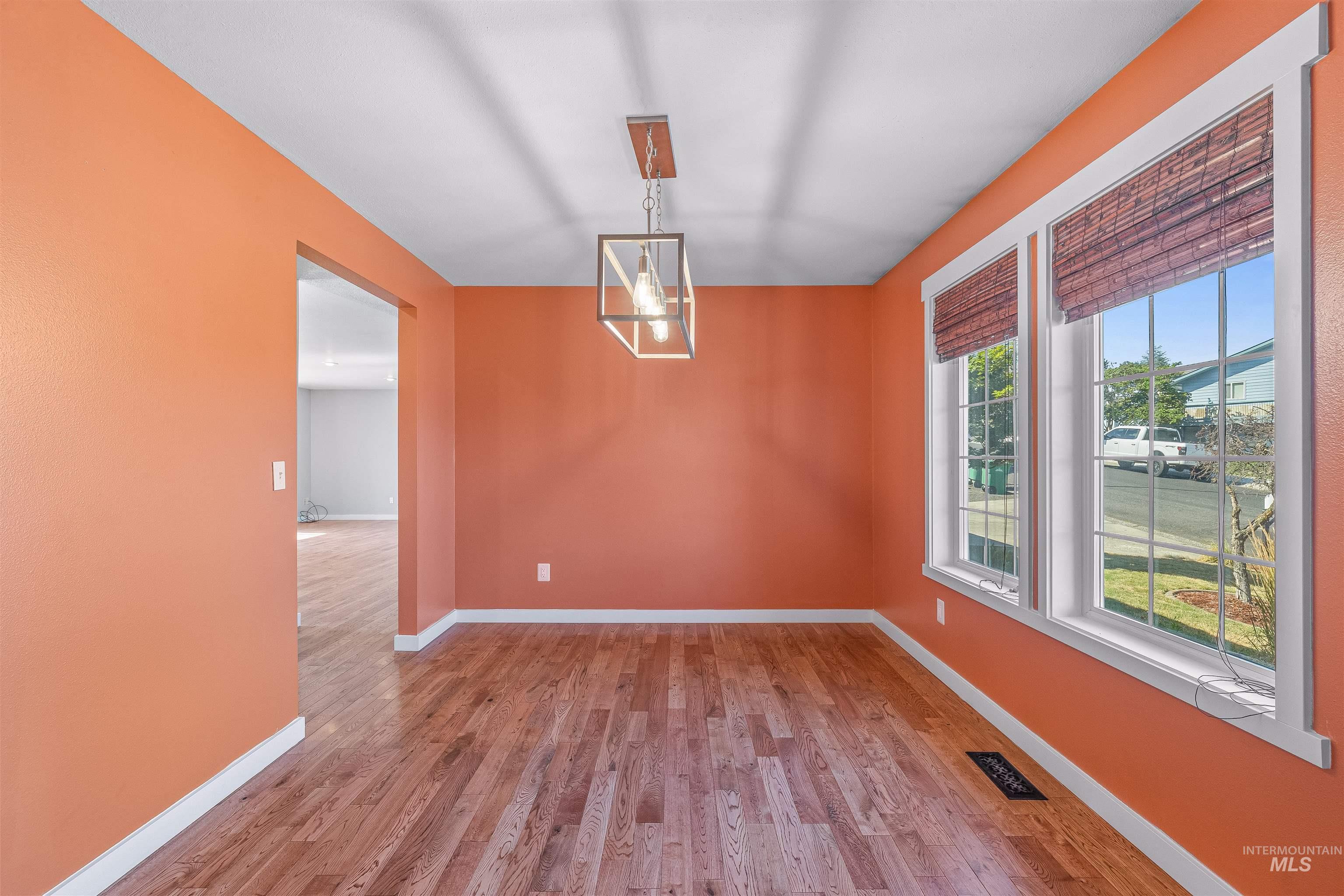 Spare room with wood finished floors and baseboards