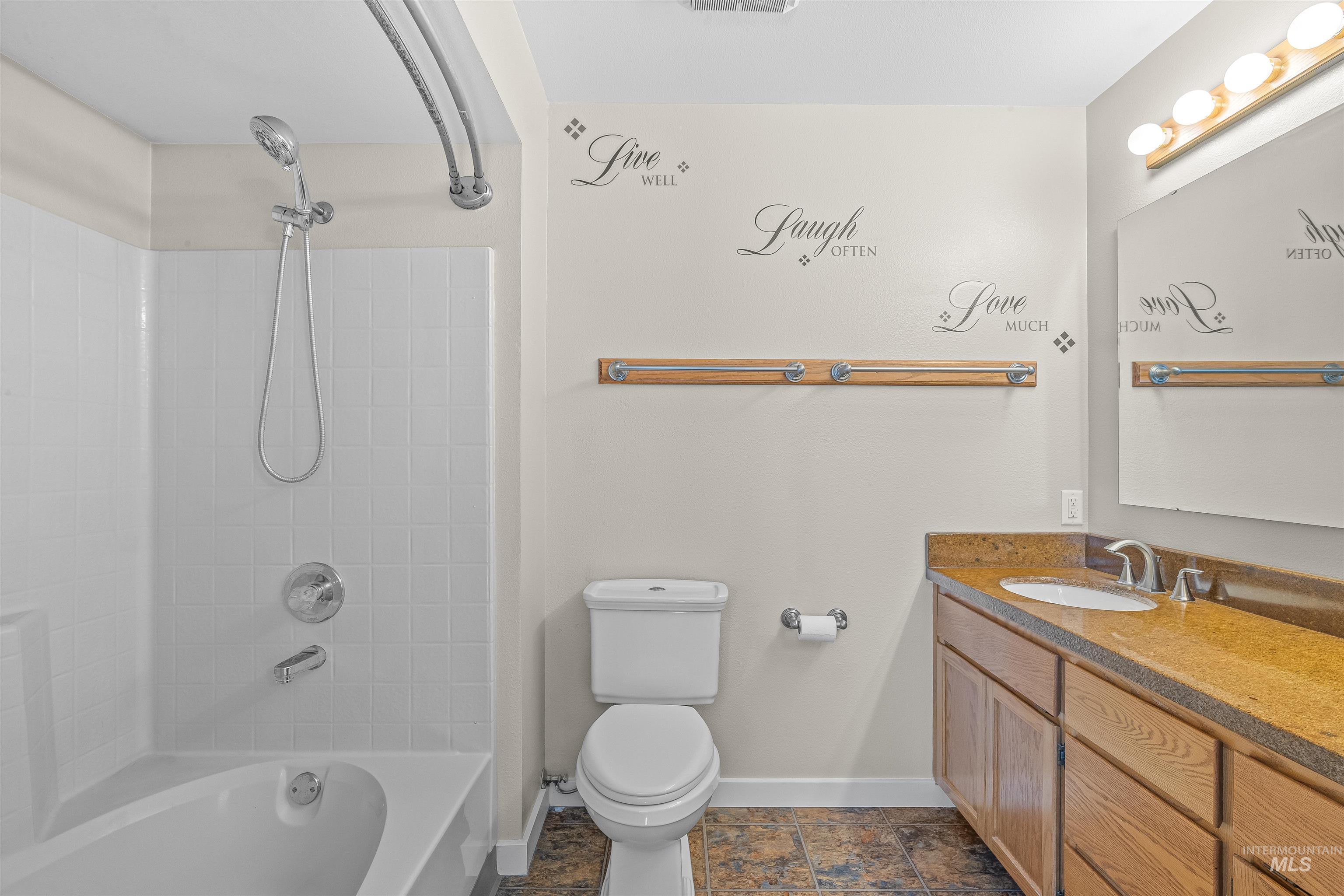 Full bath featuring vanity and  shower combination