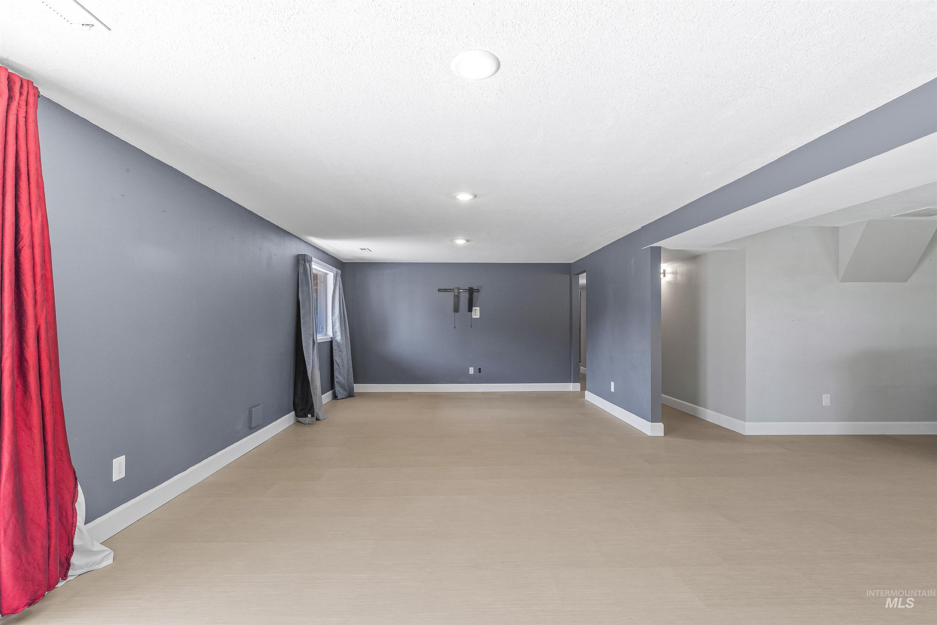 Empty room featuring baseboards and recessed lighting