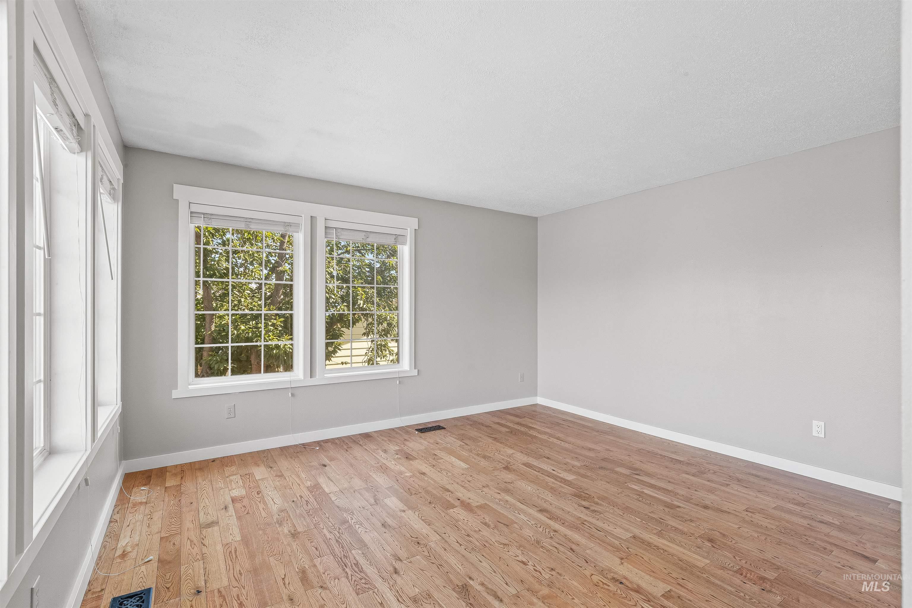 Empty room featuring light wood-type flooring and baseboards