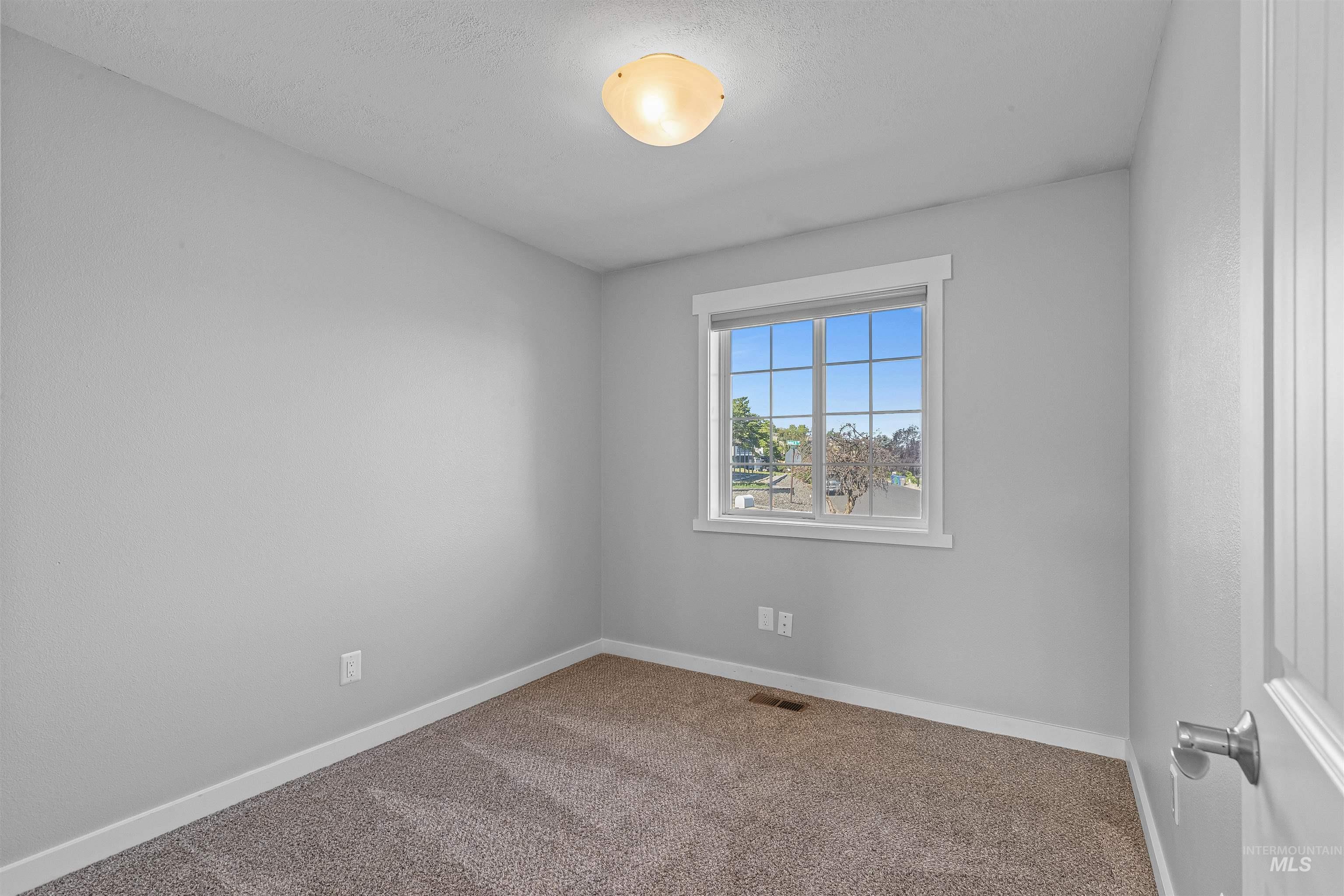 Spare room featuring carpet flooring