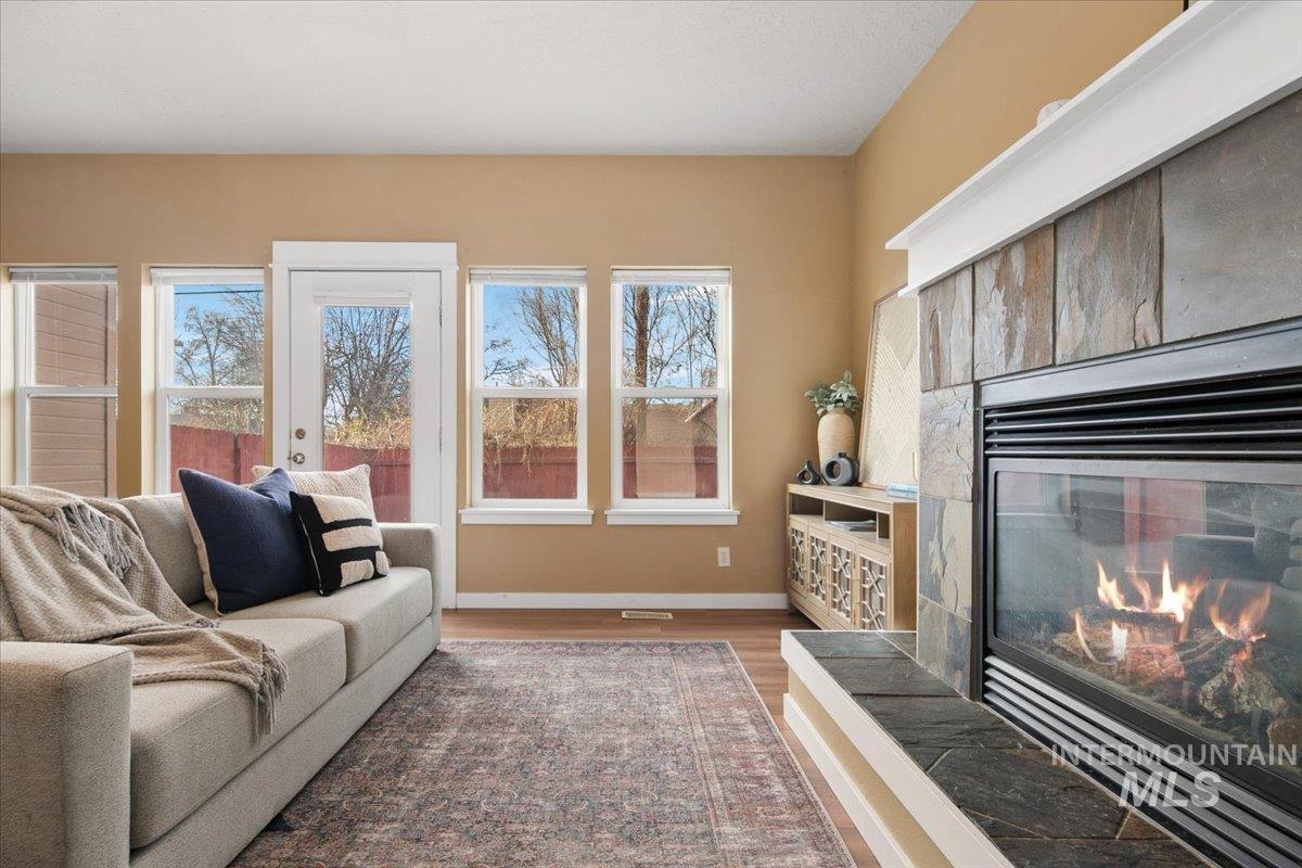 Living area featuring LVP floors and a glass covered fireplace
