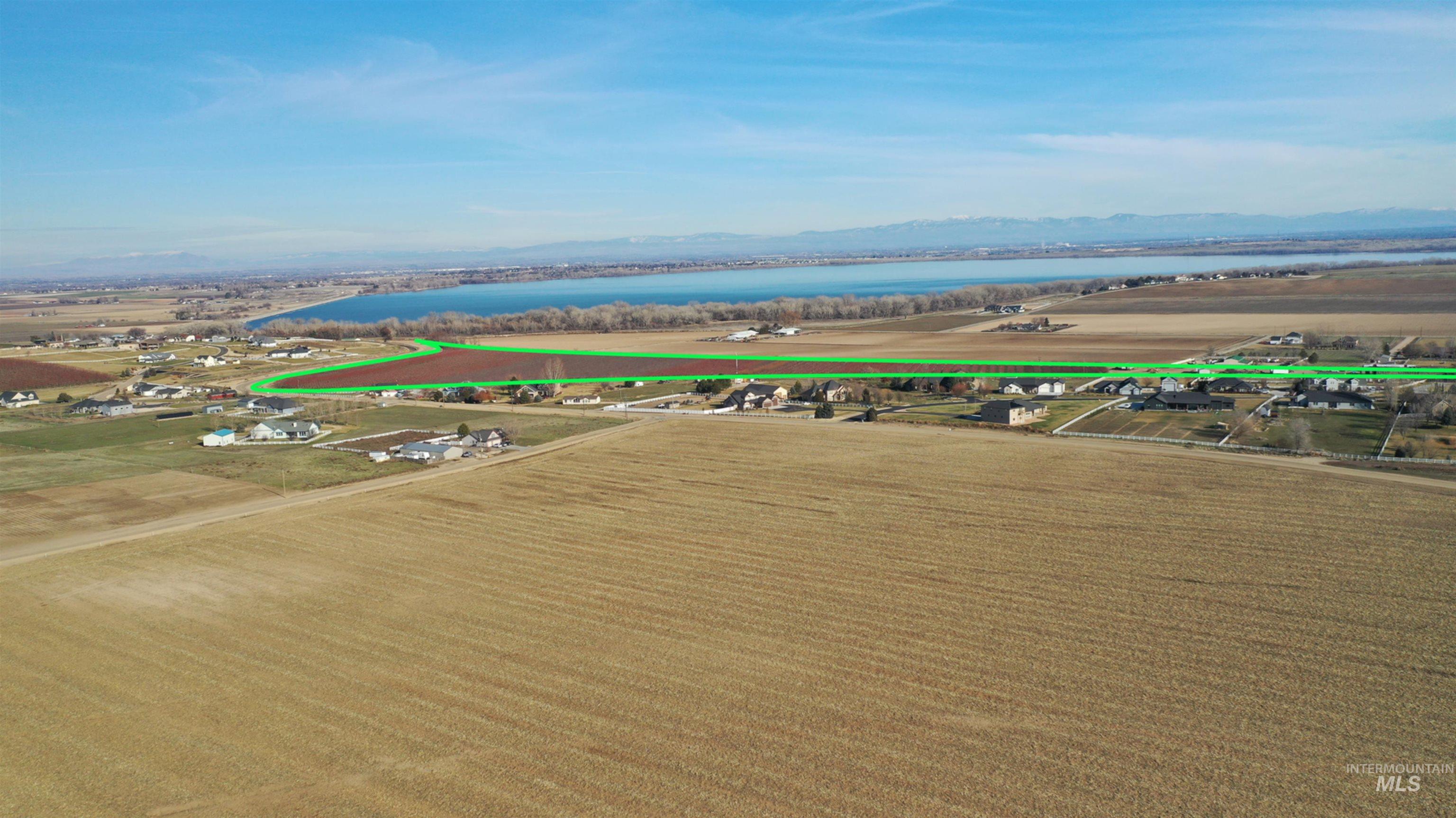 Aerial view of sparsely populated area featuring a water and mountain view and extensive farmland