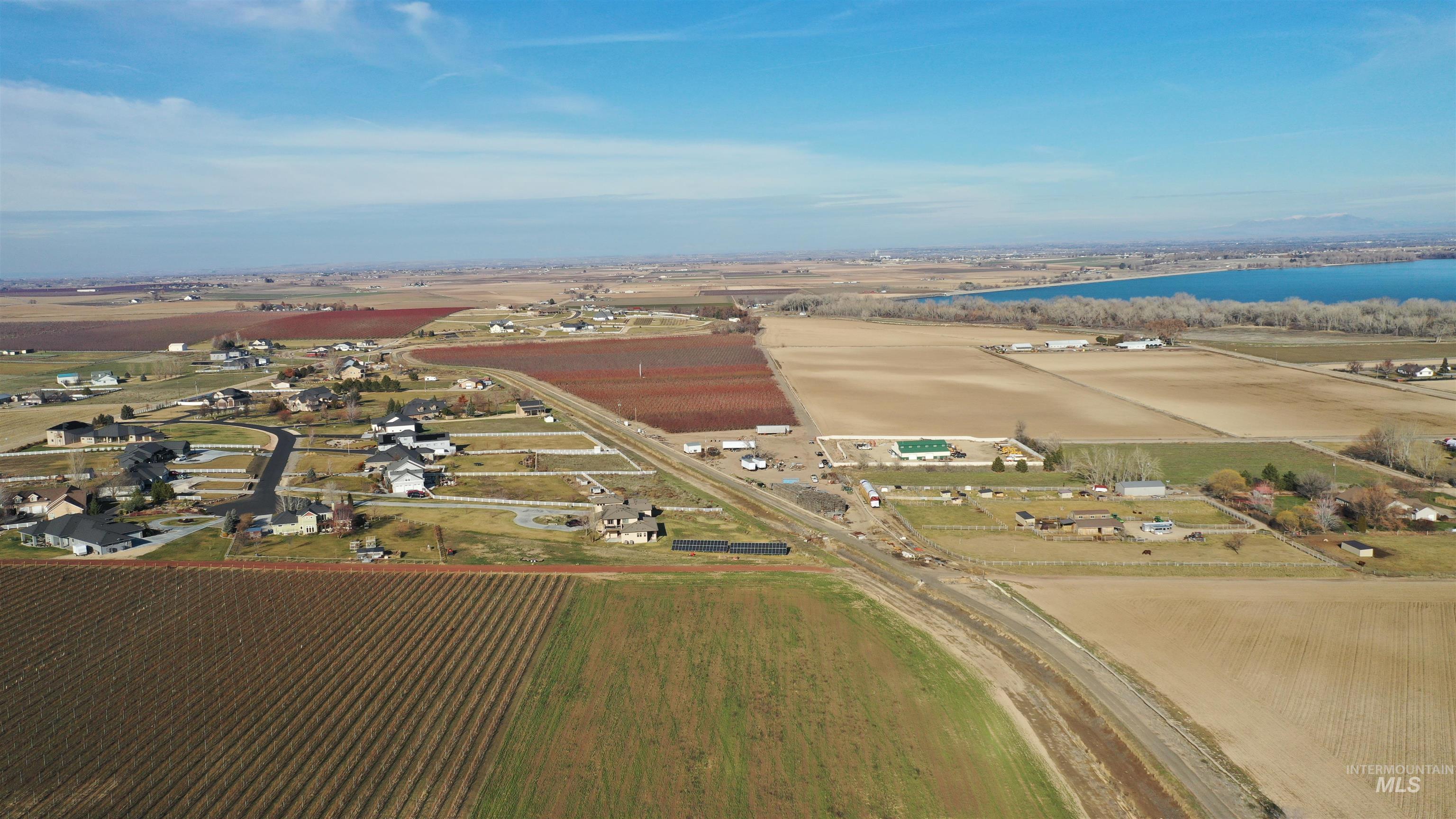 Aerial view of property and surrounding area featuring rural landscape and abundant farmland