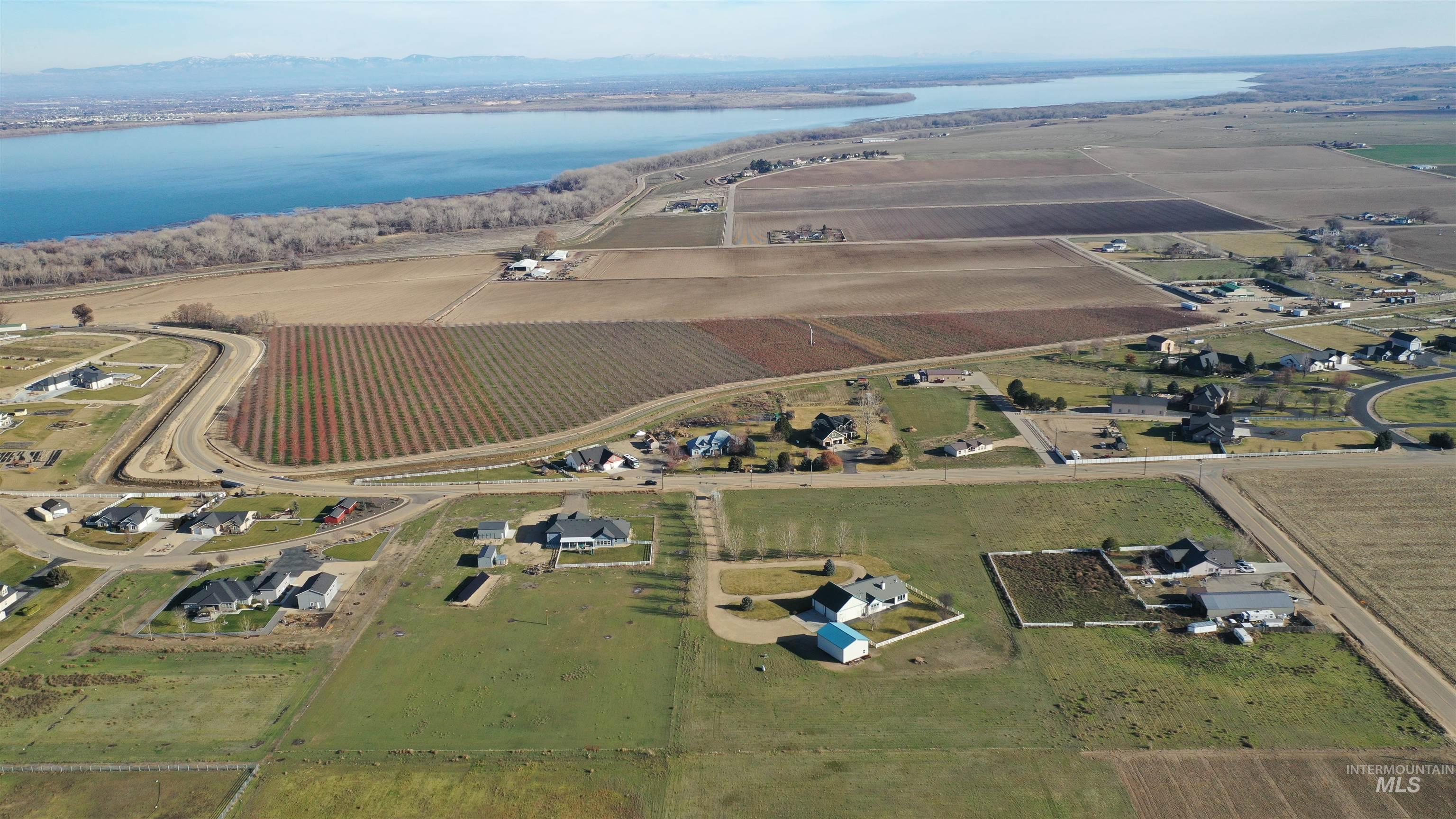 Aerial view of property and surrounding area featuring extensive farmland and rural landscape
