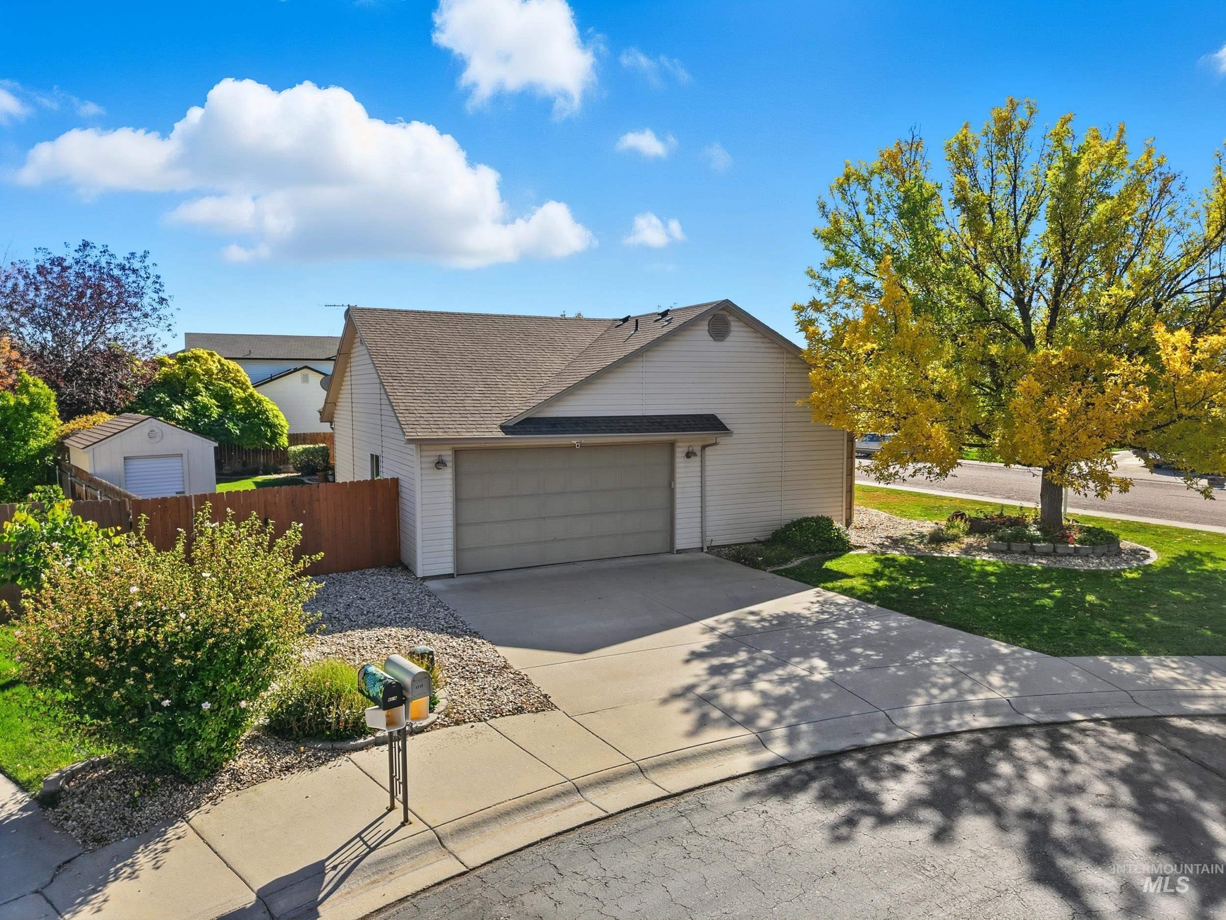 View of home's exterior featuring concrete driveway, a garage, and roof with shingles