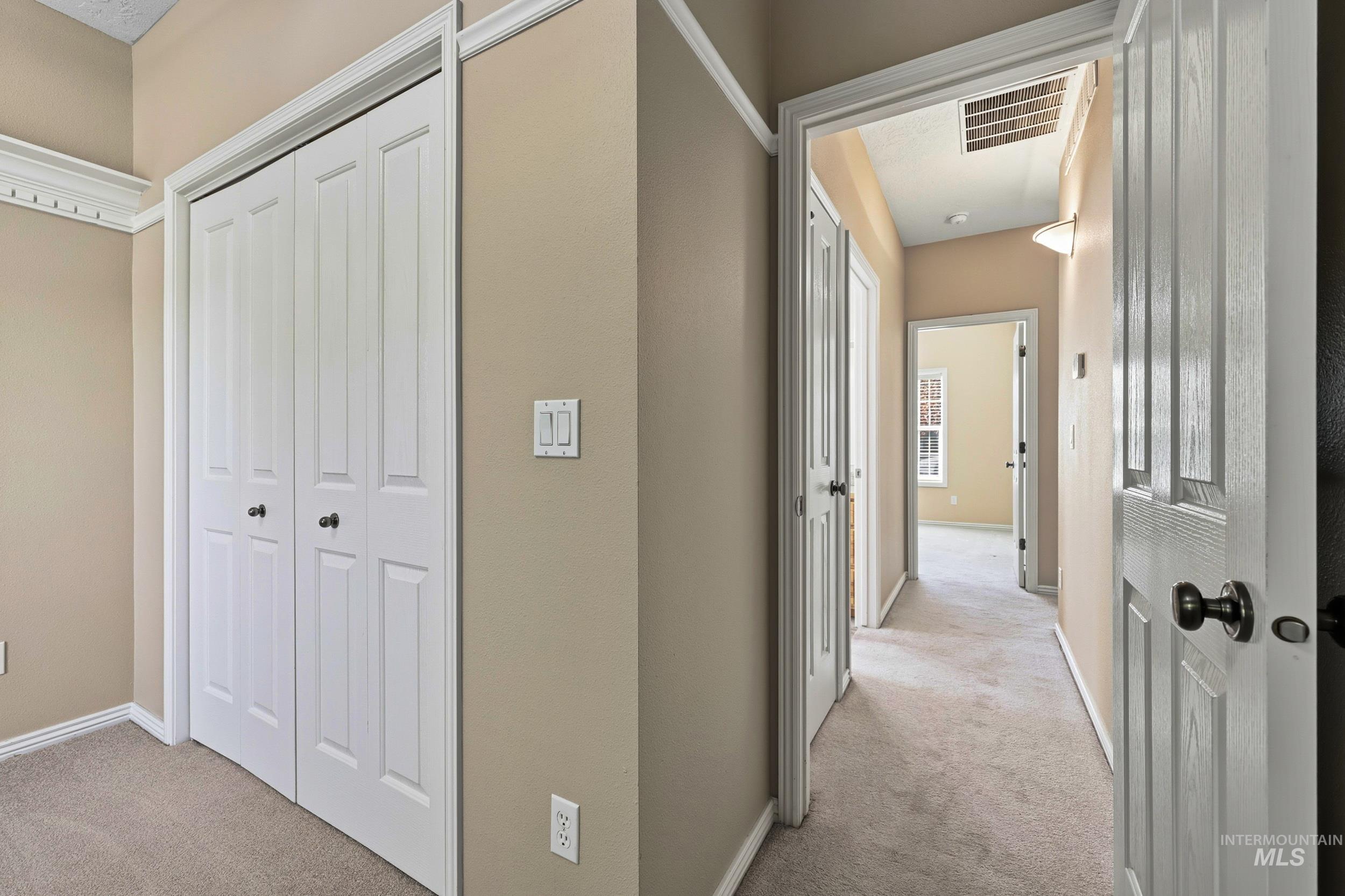 Hallway with light carpet