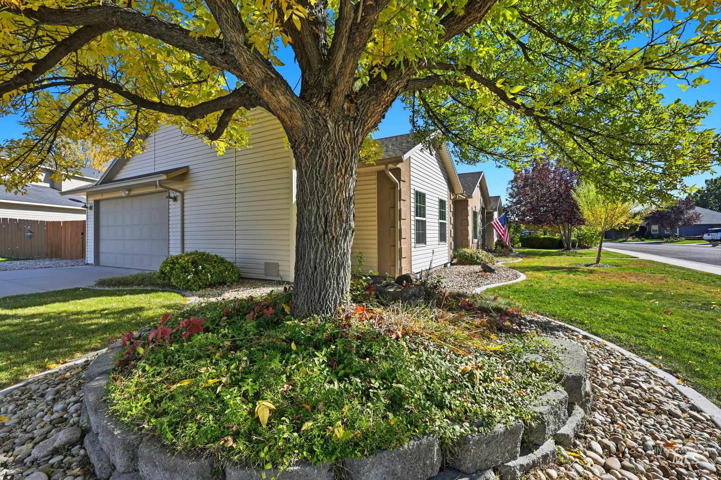 View of side of home with a lawn, driveway, and a garage