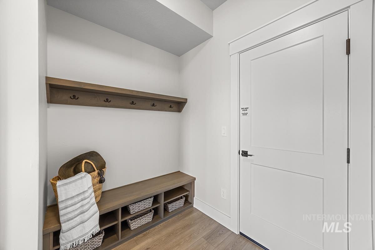 Built-in mudroom bench with cubby storage and a coordinating wall shelf featuring coat hooks