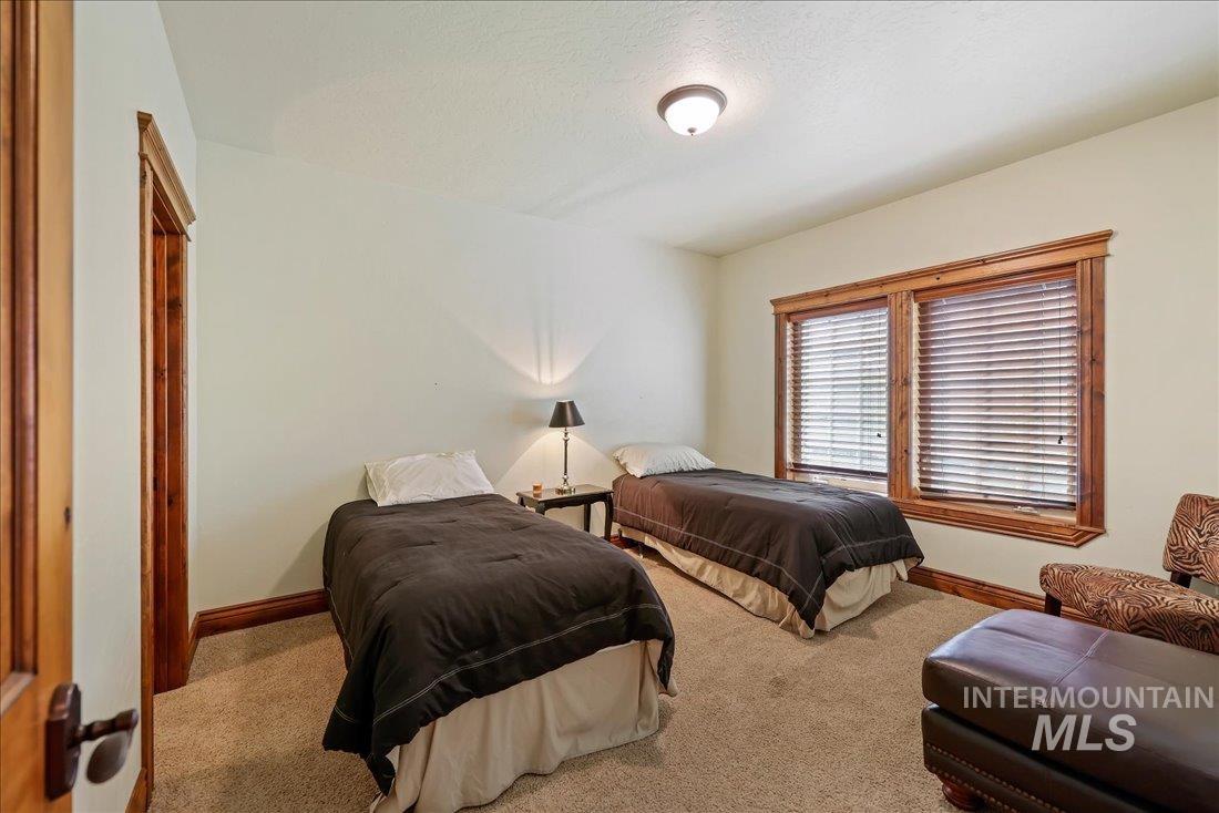 Carpeted bedroom featuring baseboards