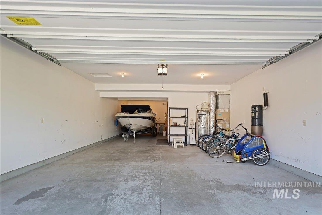 Garage featuring a garage door opener and a central vacuum unit