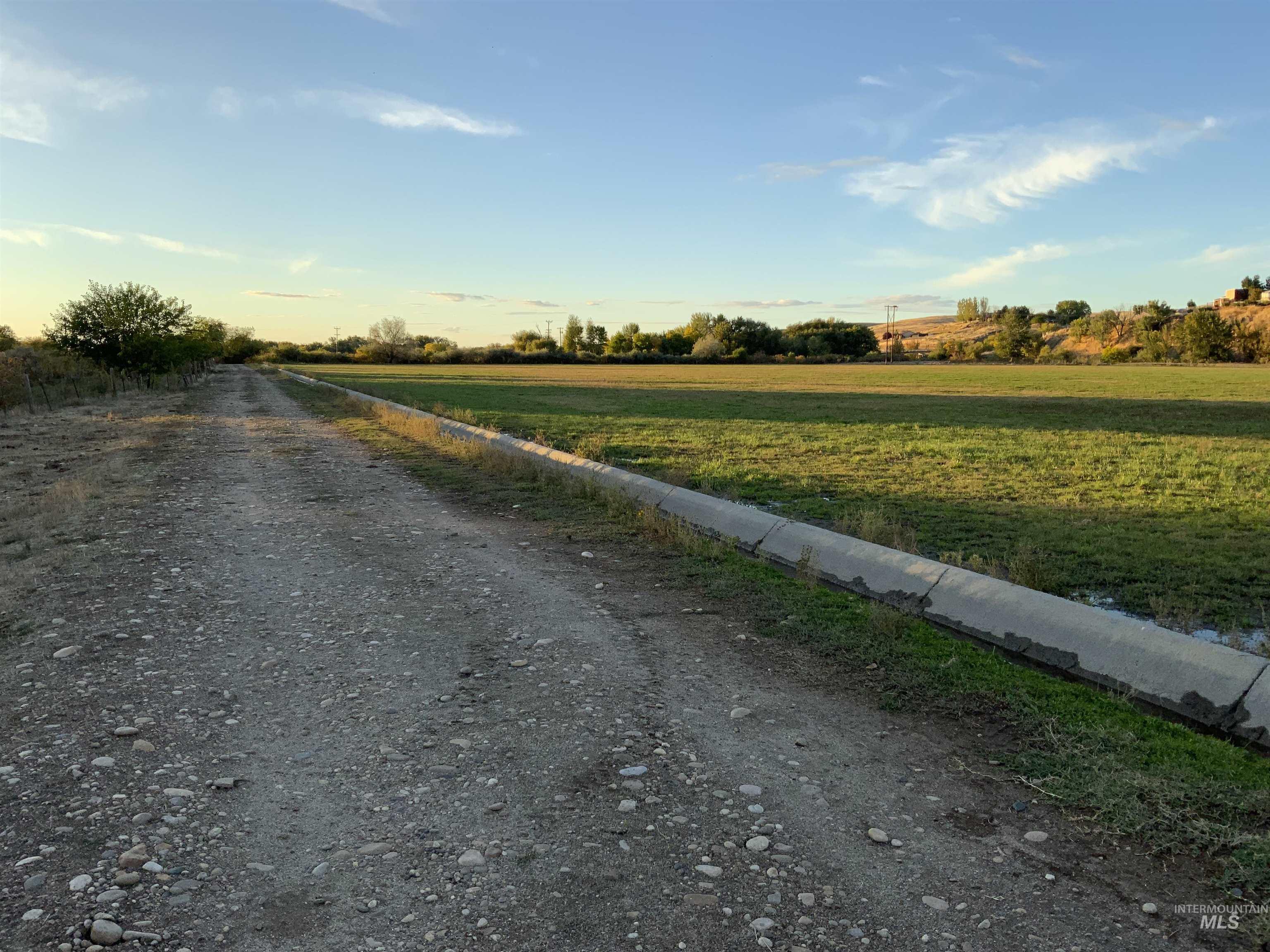 View of dirt / gravel road with a view of countryside