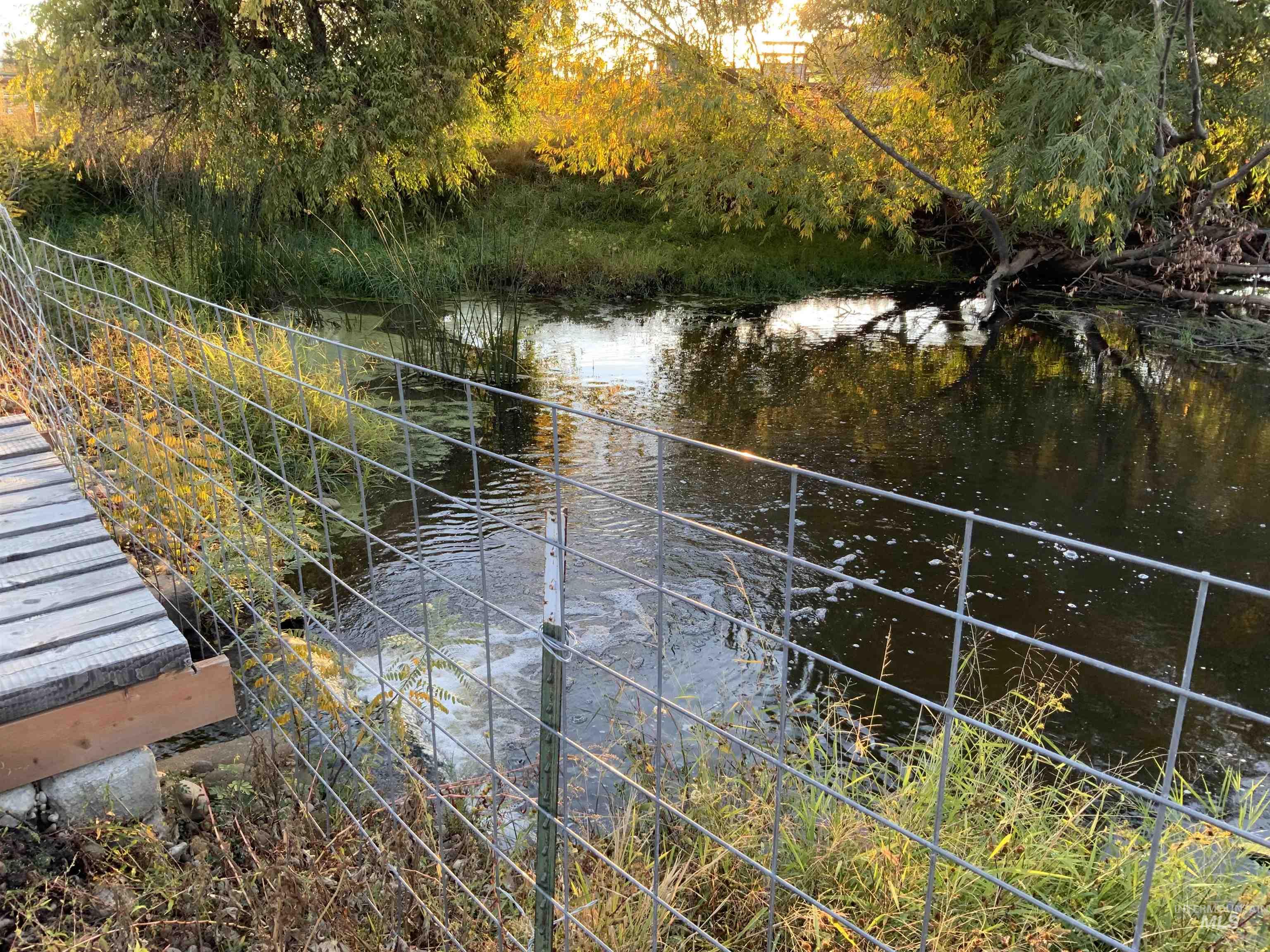 View of yard with a water view and a balcony