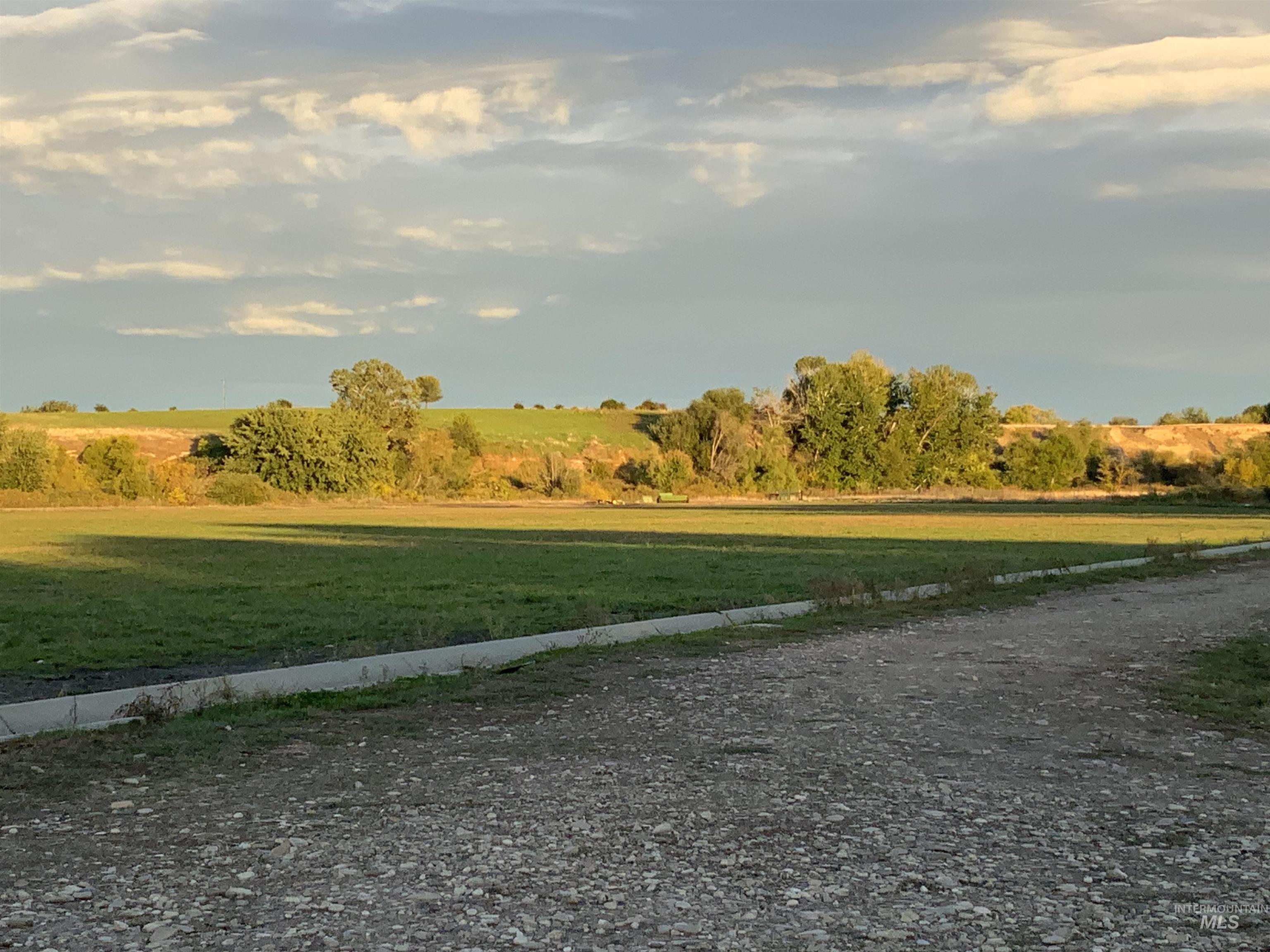 View of dirt / gravel road with a rural view