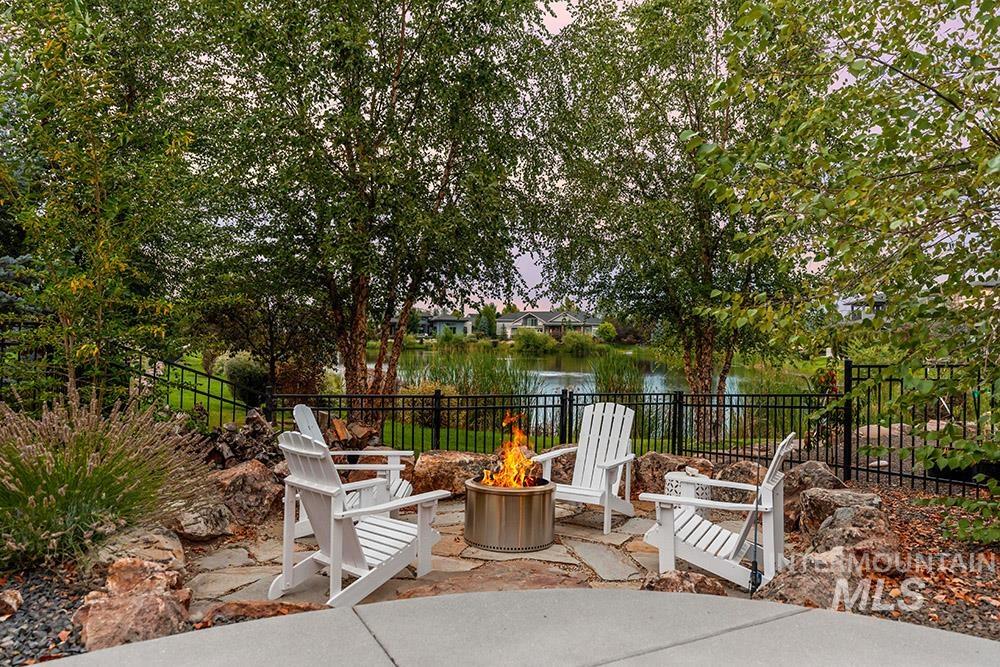 View of patio / terrace featuring an outdoor fire pit and a water view