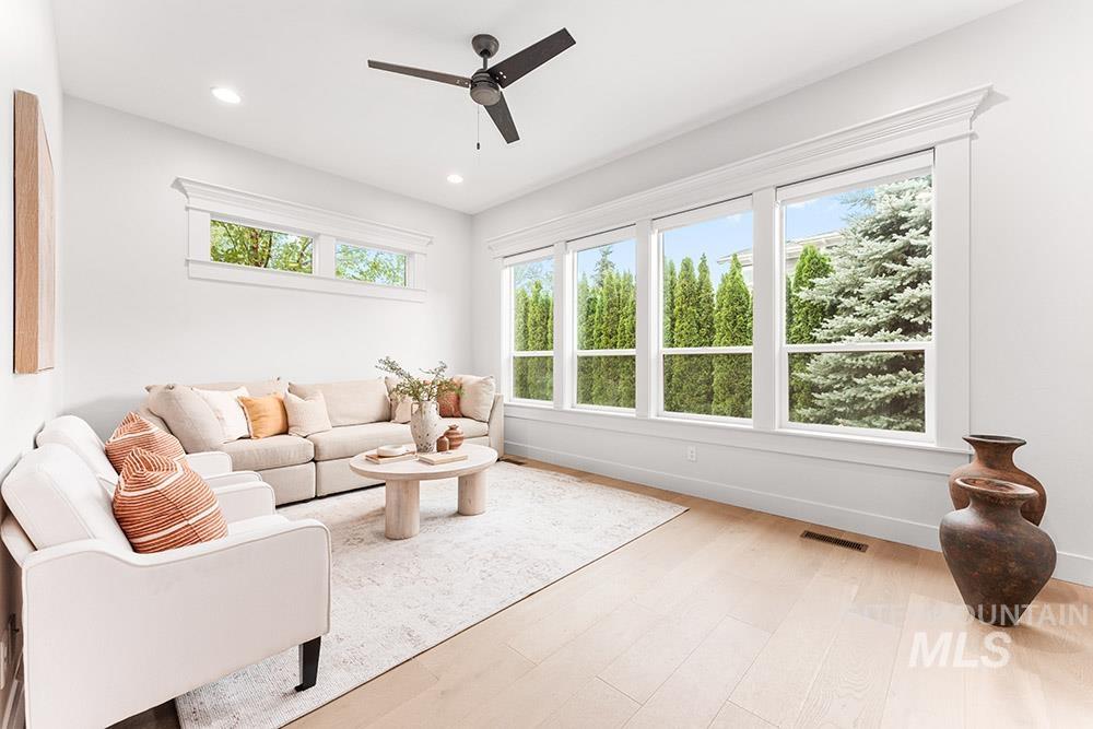Living area featuring light wood finished floors, recessed lighting, and ceiling fan