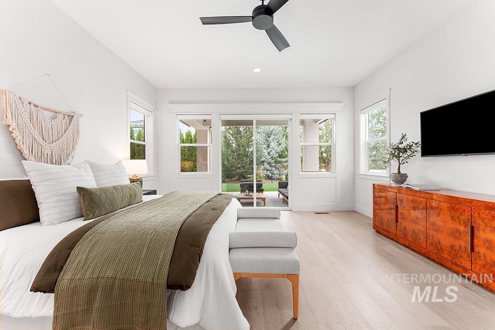 Bedroom featuring light wood finished floors, multiple windows, a ceiling fan, access to outside, and recessed lighting