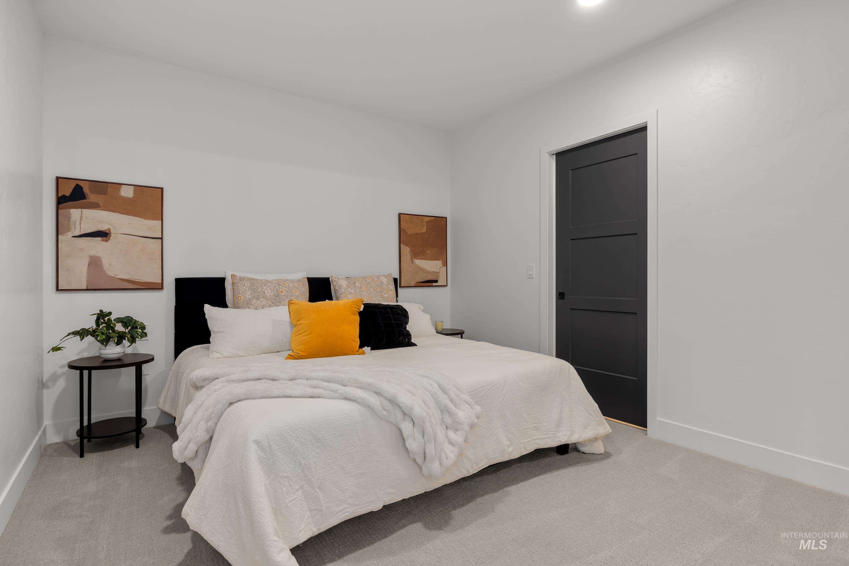 Bedroom with light carpet and baseboards