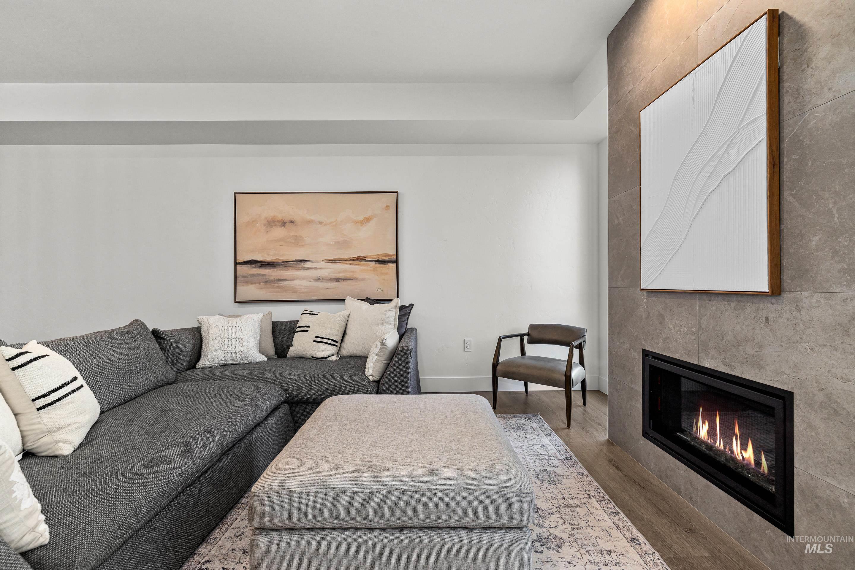 Living room with wood finished floors and a fireplace