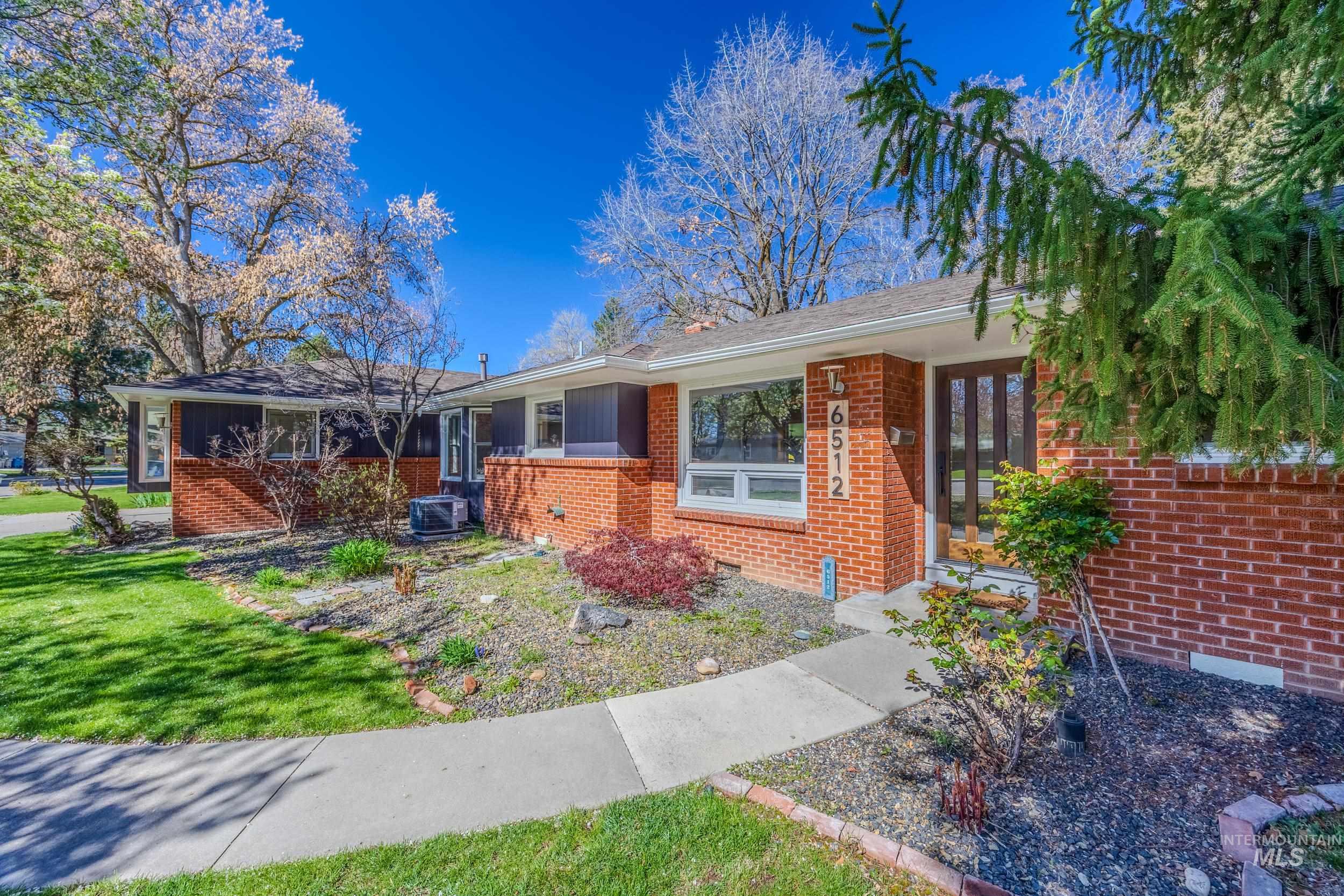 Ranch-style home with brick siding and a front yard