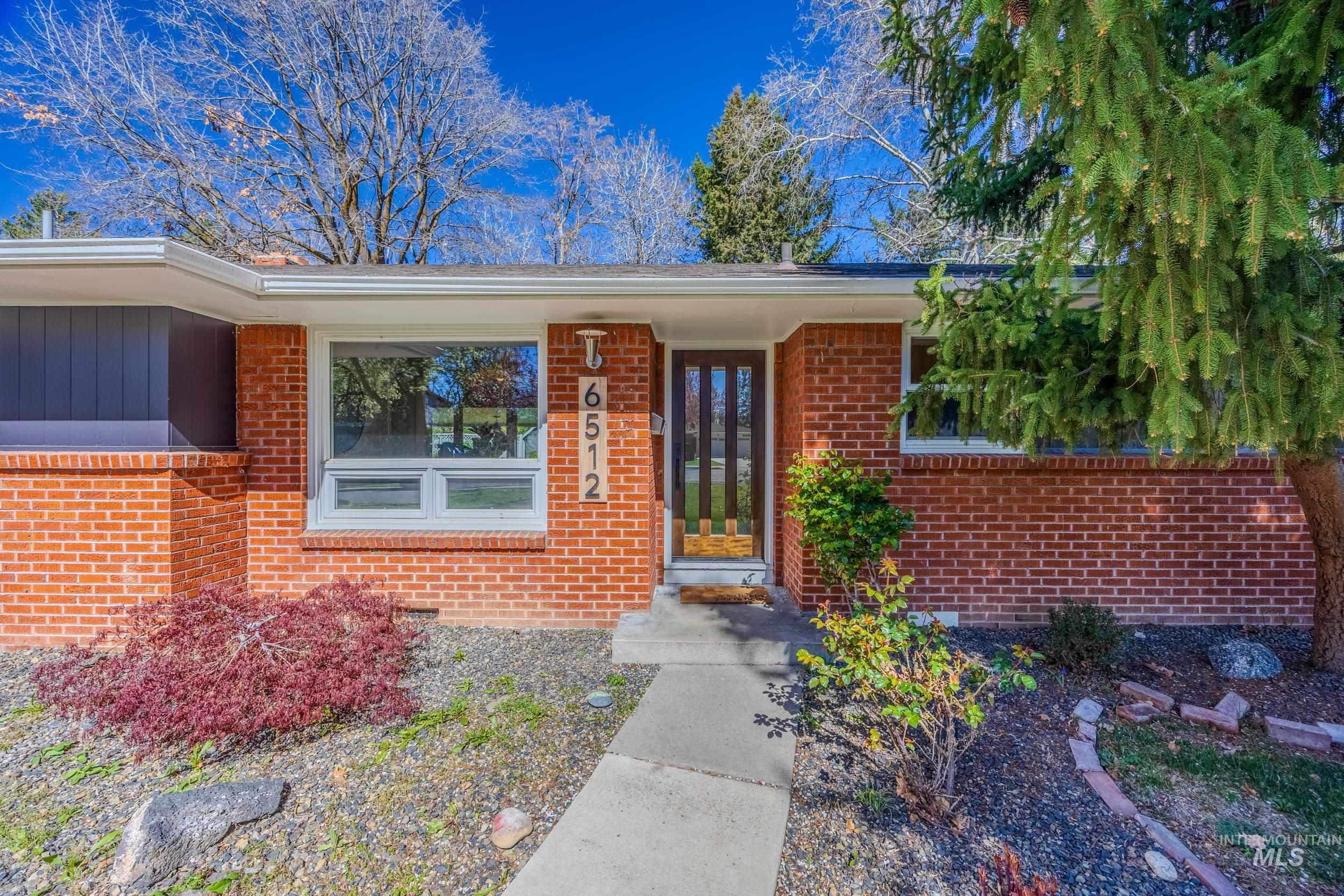 Doorway to property featuring brick siding