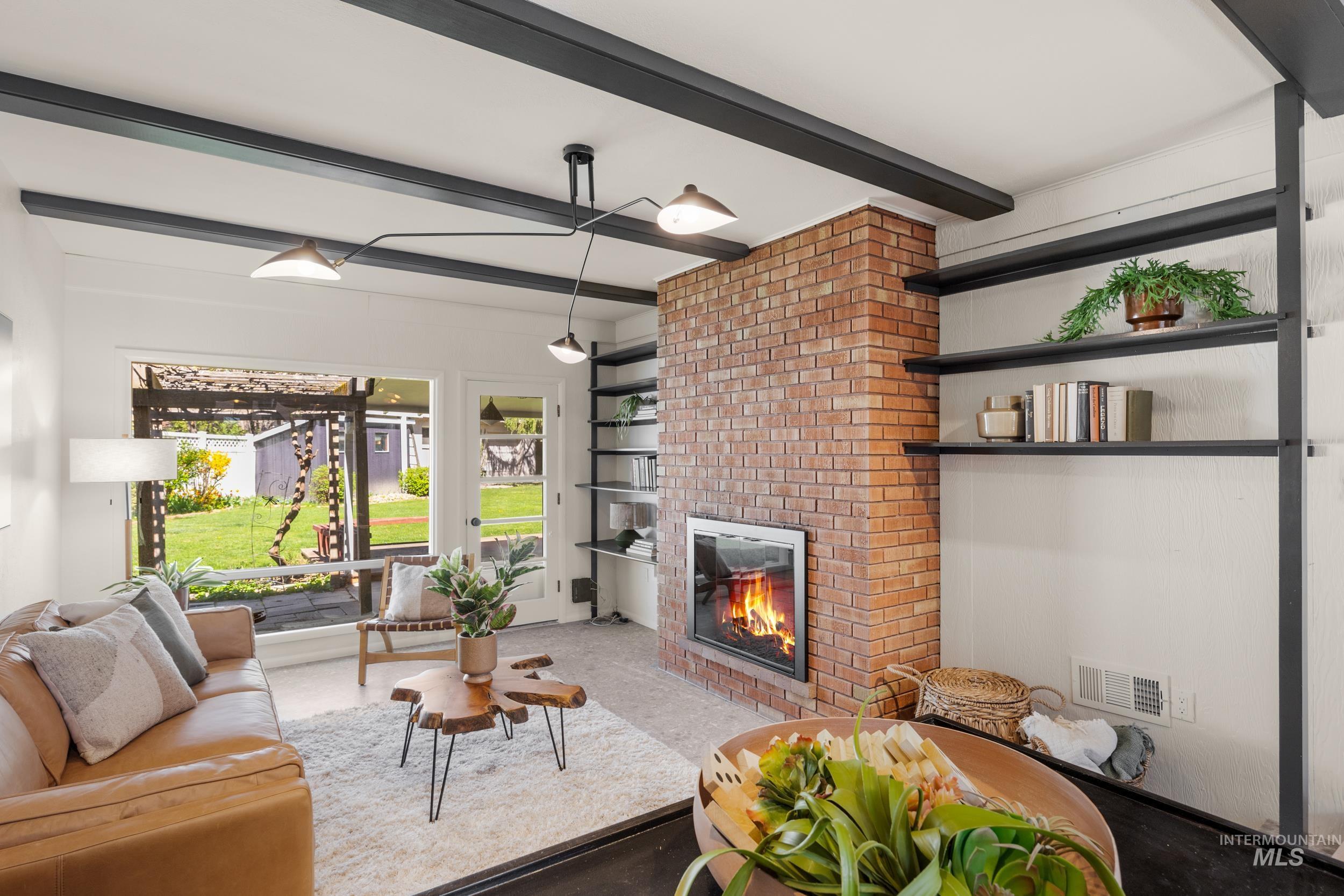 Living area with a fireplace and beamed ceiling