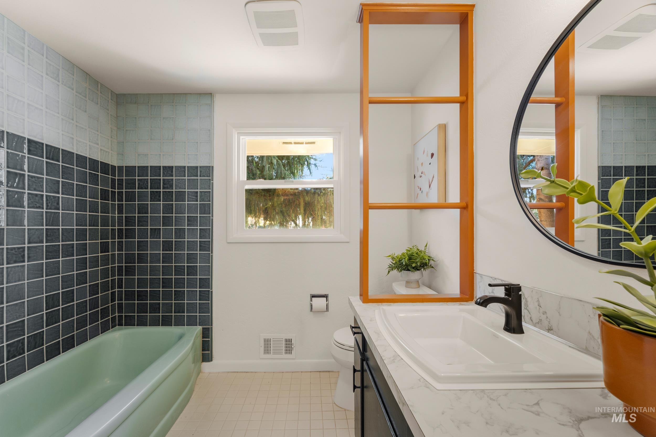 Bathroom with vanity and a tub to relax in