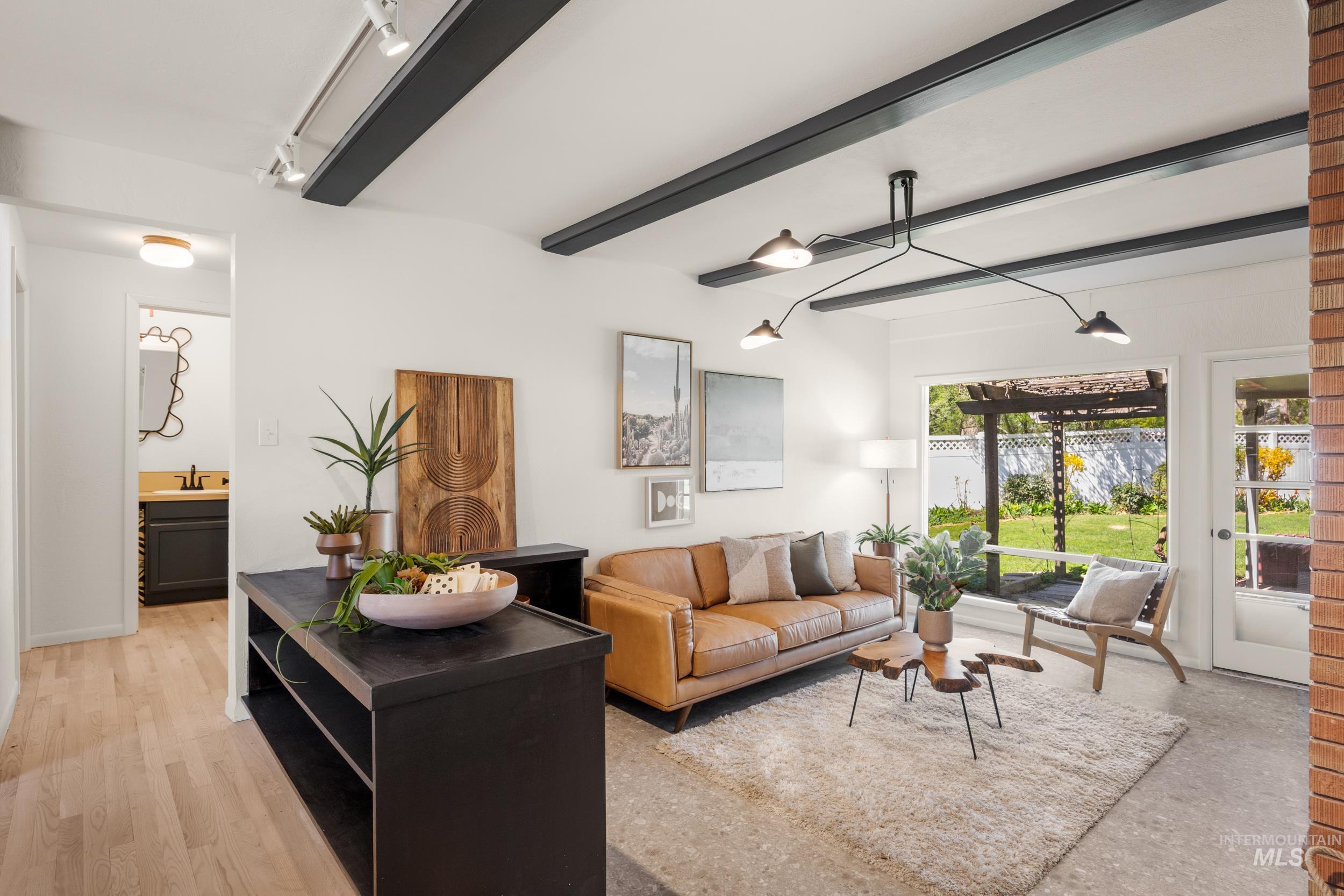 Living room with beamed ceiling and track lighting