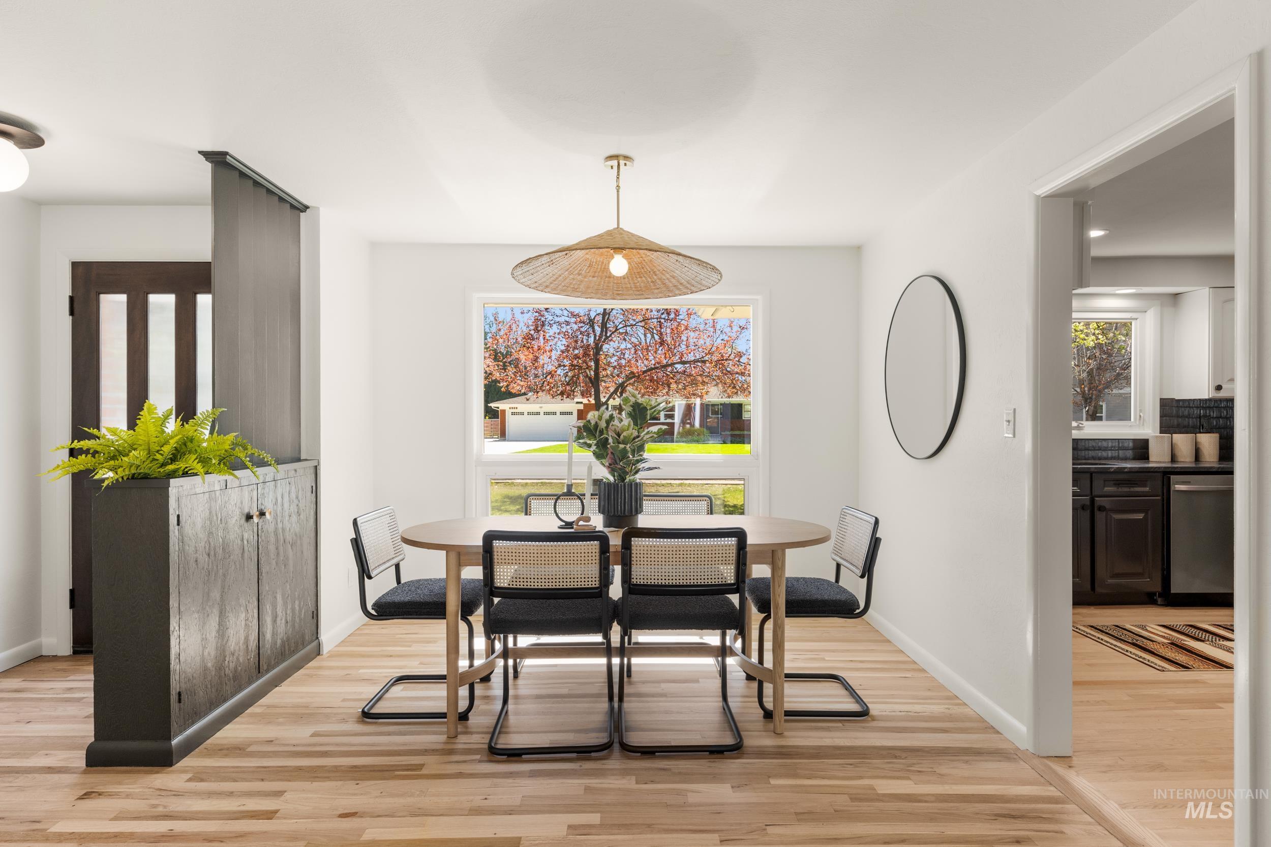 Dining space with light wood-type flooring and baseboards