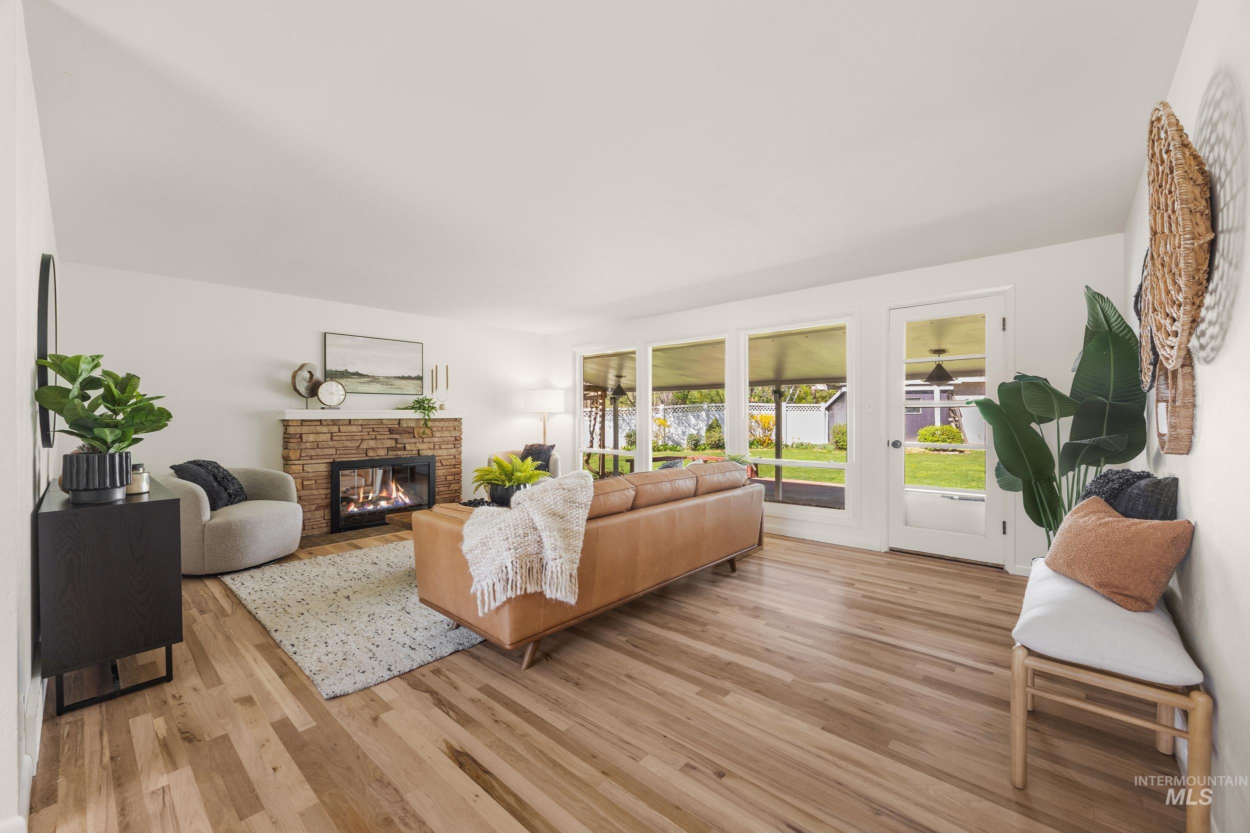 Living room featuring light wood finished floors and a fireplace