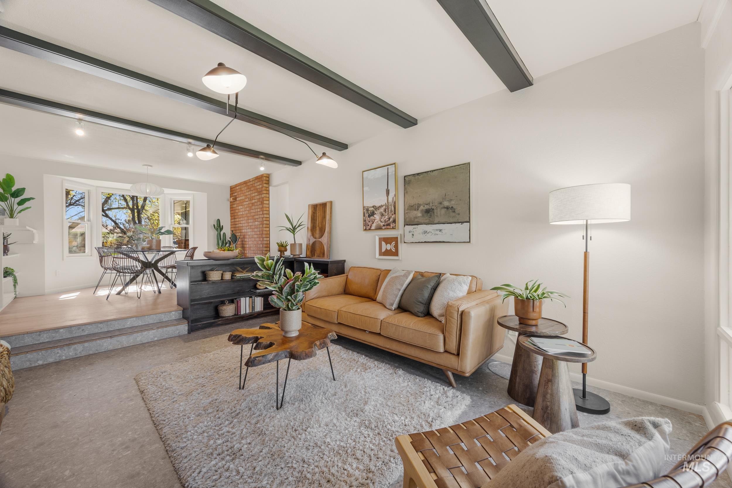 Living room featuring beamed ceiling