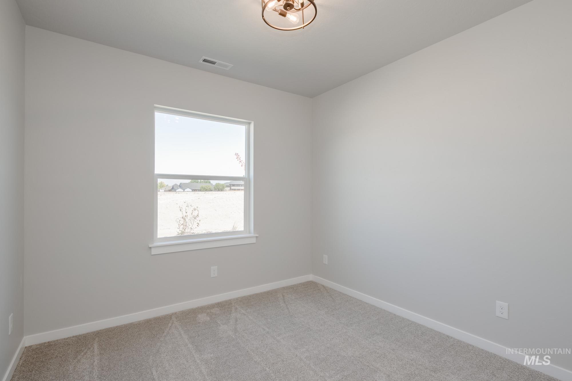 Empty room with carpet flooring and baseboards