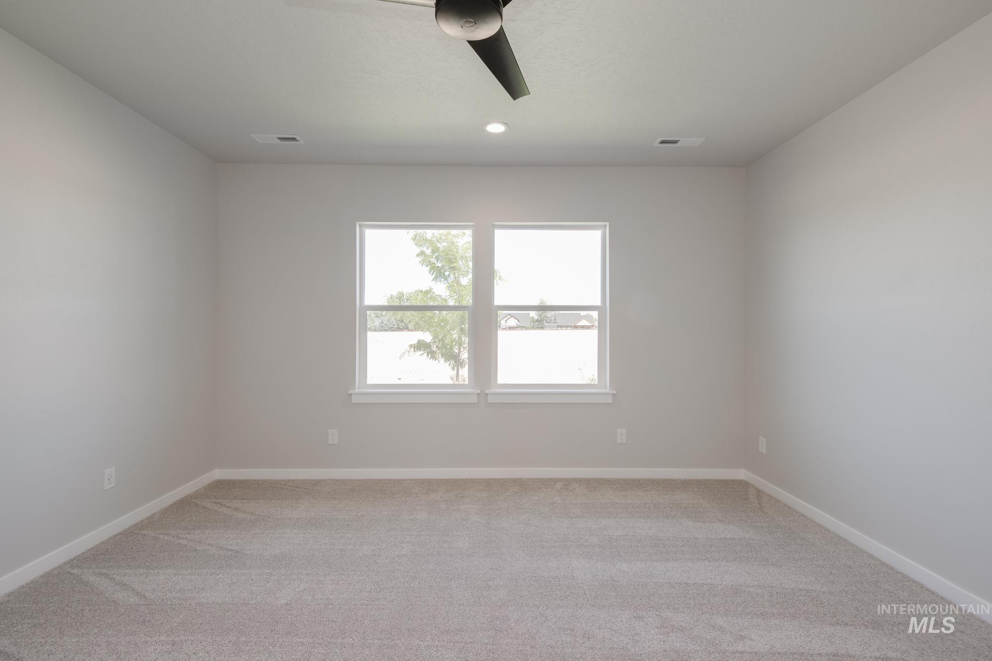 Spare room with light carpet, a ceiling fan, and recessed lighting