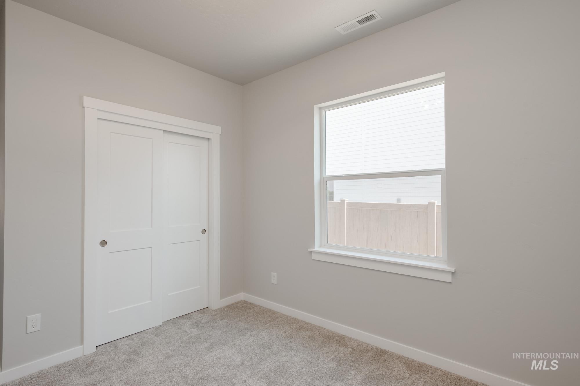 Unfurnished bedroom with carpet floors and a closet