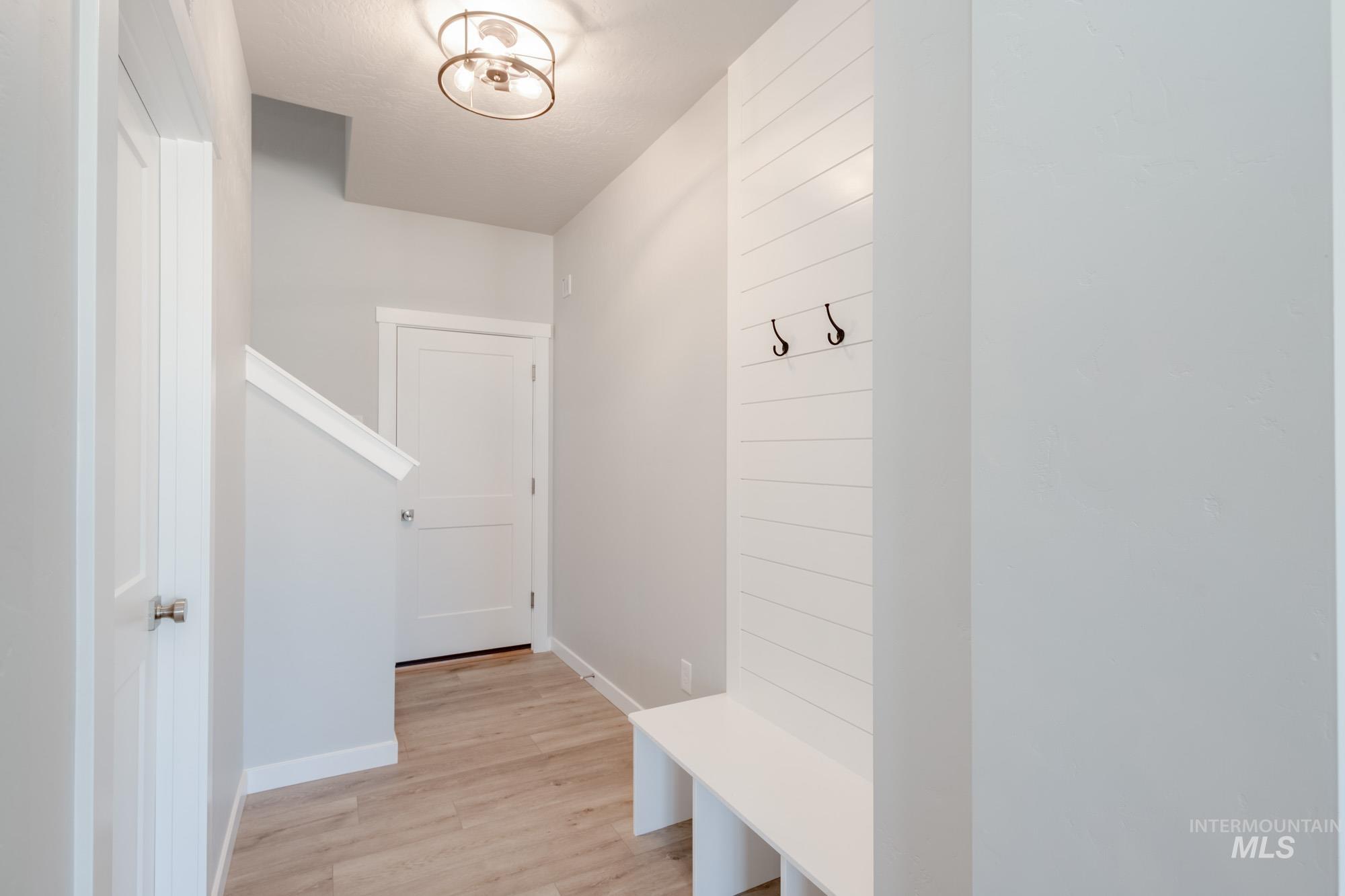 Mudroom with baseboards and light wood-style floors