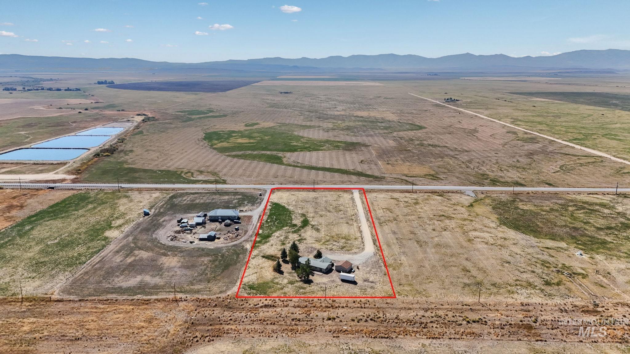 View of rural area featuring a mountainous background and property boundaries highlighted