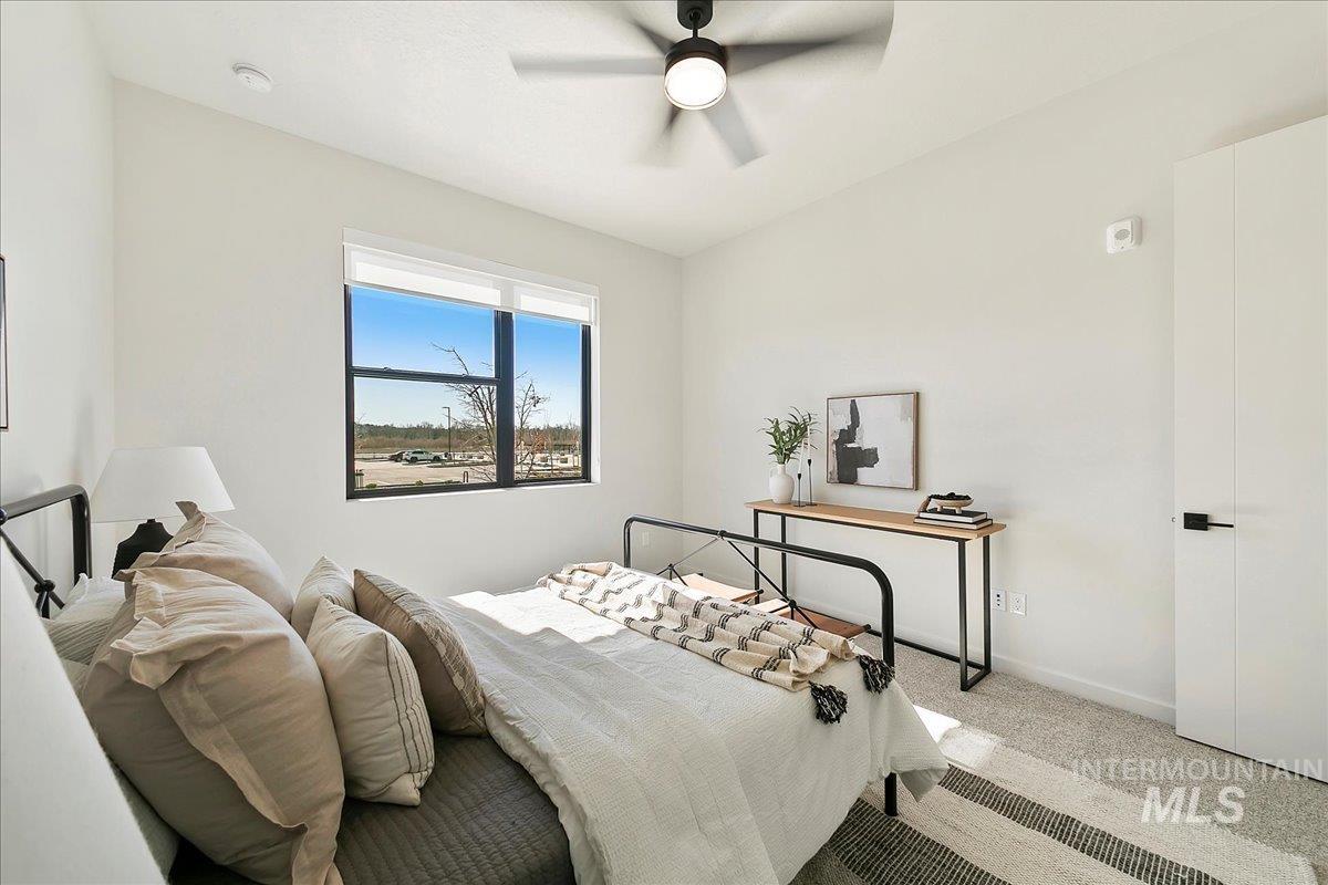 Carpeted bedroom with baseboards and ceiling fan