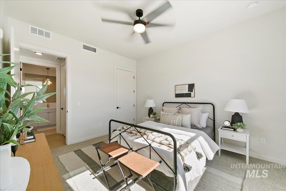 Bedroom featuring light carpet and ceiling fan