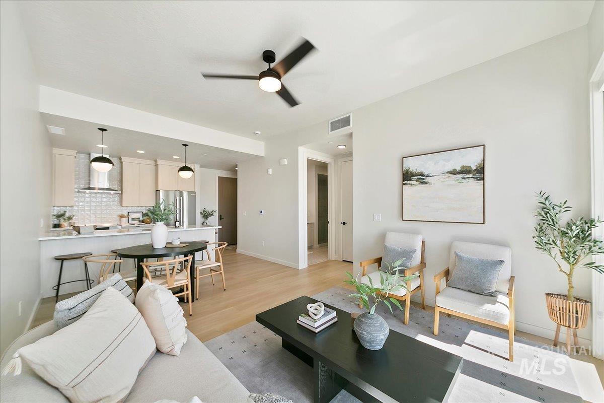 Living area featuring light wood-style floors, recessed lighting, and ceiling fan