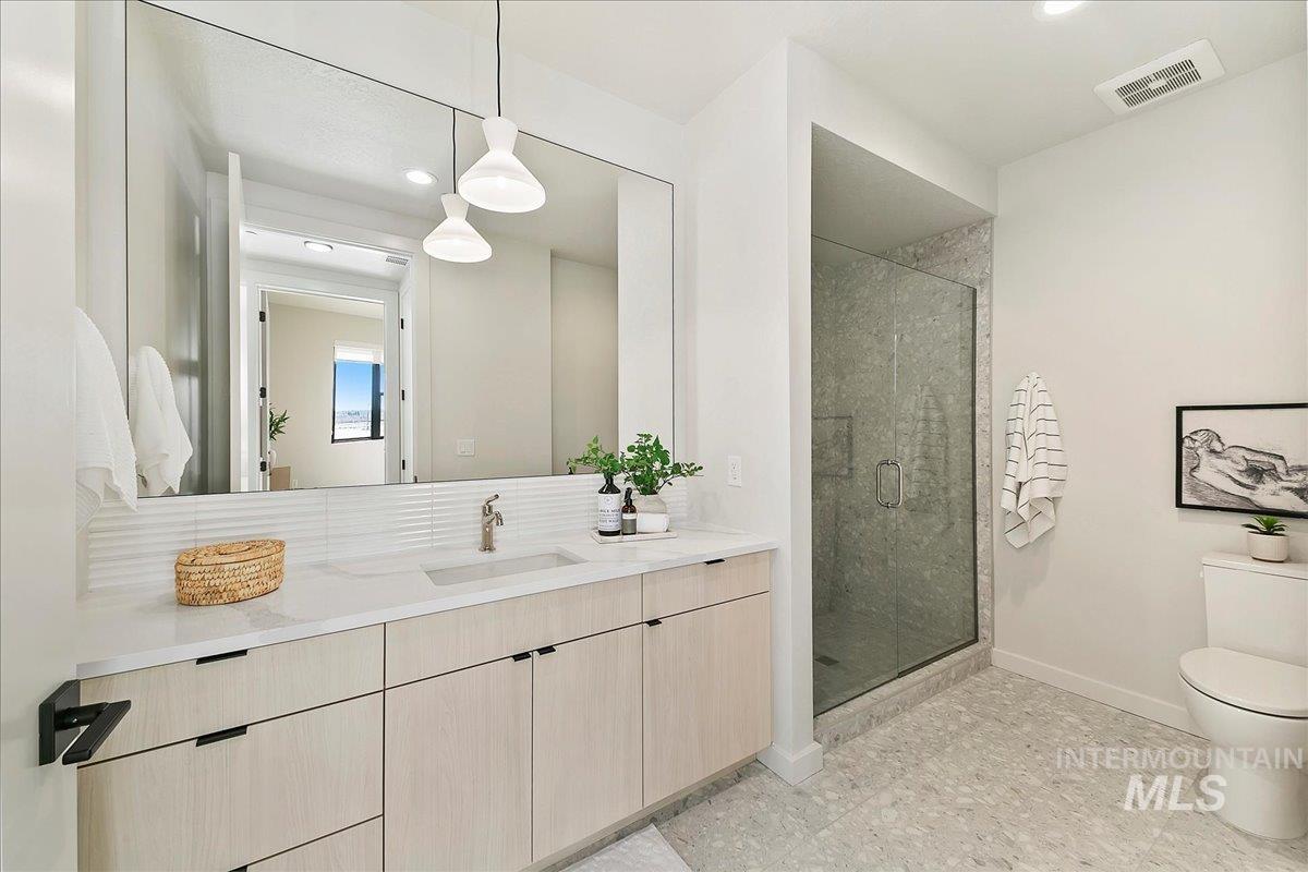 Full bath featuring a shower stall, vanity, and recessed lighting