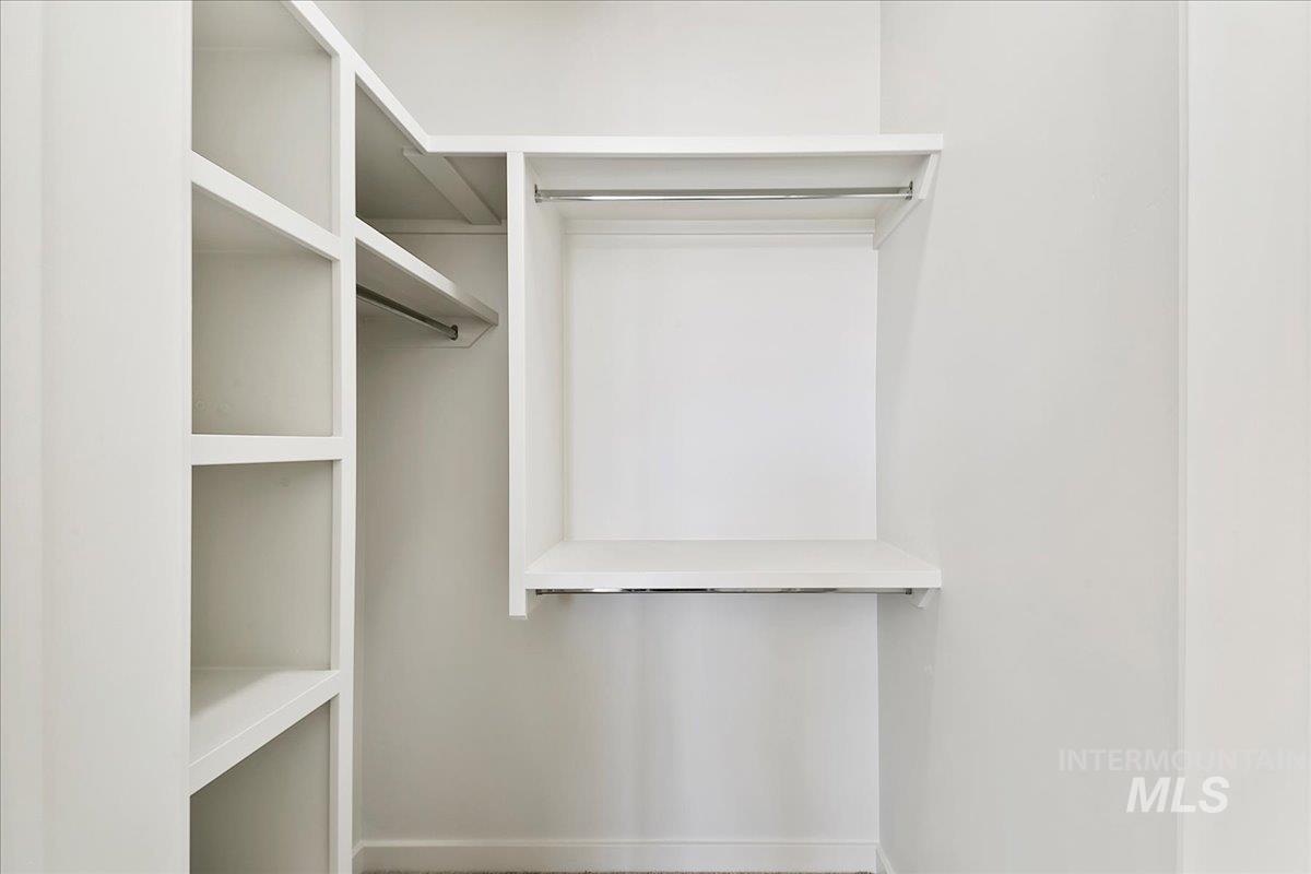 Walk in closet featuring carpet flooring