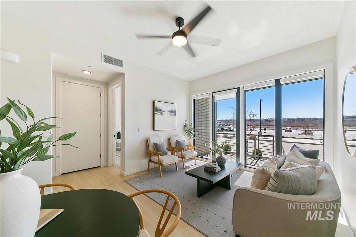 Living room featuring ceiling fan and light wood-type flooring