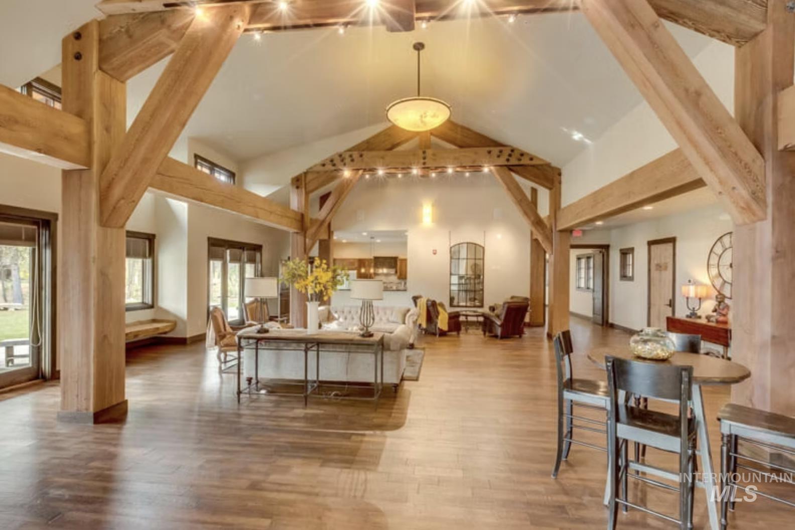 Common area with high vaulted ceiling and beam ceiling