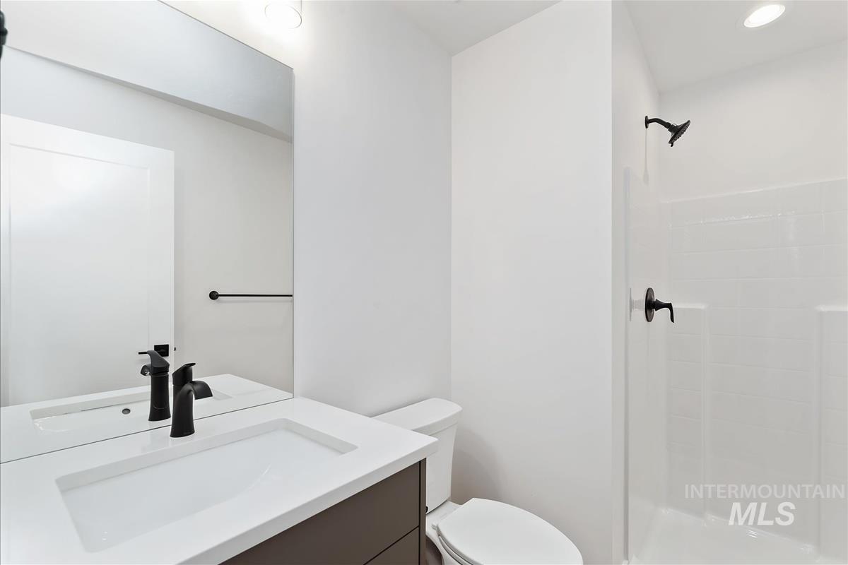 Bathroom featuring vanity, a stall shower, and recessed lighting