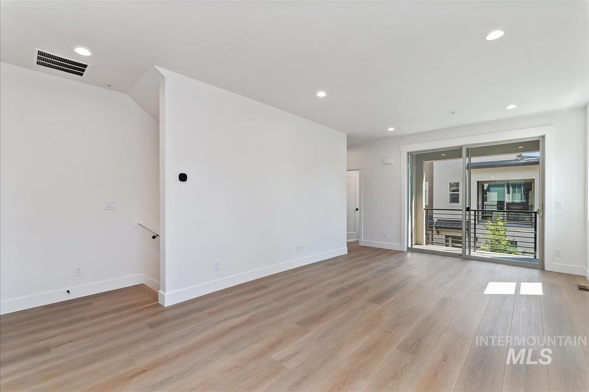 Spare room featuring recessed lighting and light wood-type flooring
